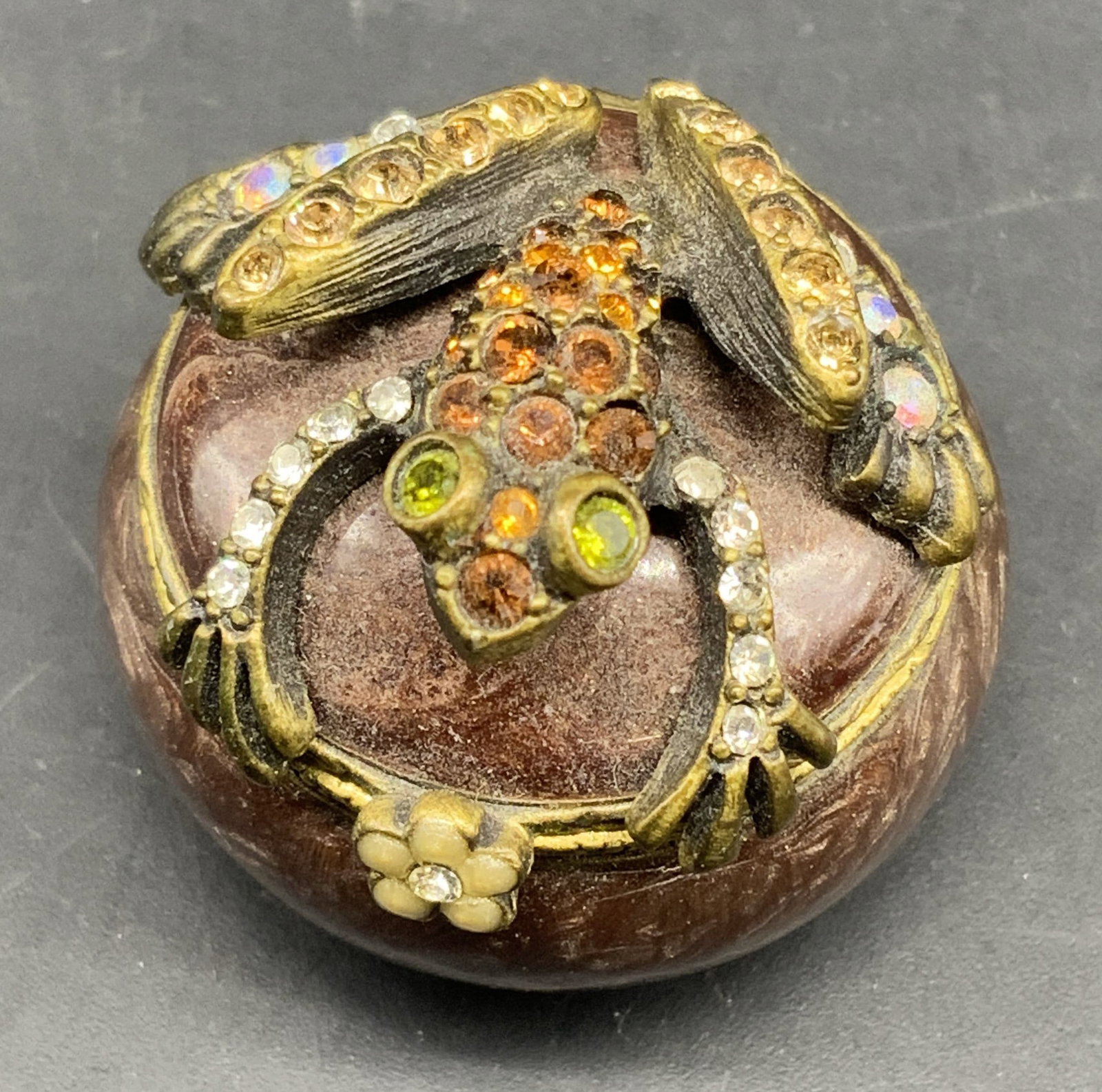 Jay STRONGWATER enamel frog pillbox: Signed Jay Strongwater Frog pillbox, a round enameled metal collectible decorated with Swarovski crystals and a jeweled frog on top, app 1.25 inches diameter and 1 inch ht, smalls