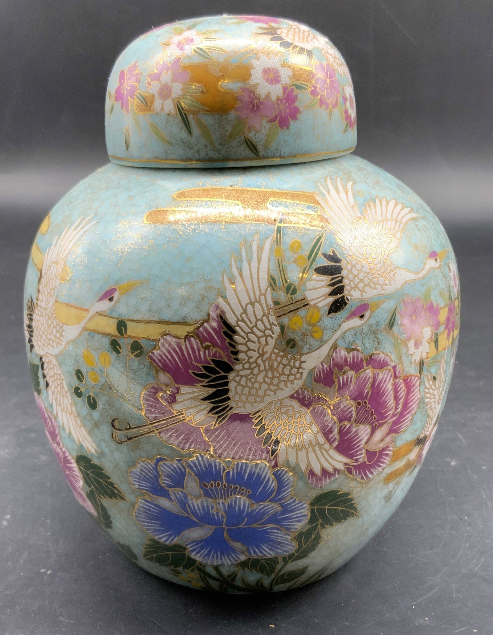 Vntg Turquoise Glazed Lidded Ginger Jar Gumps: Vintage turquoise glazed lidded ginger jar with hand painted cranes, florals and gold accents, label for Gumps department store San Francisco, and marked made in China label measures ht app 7 inches,