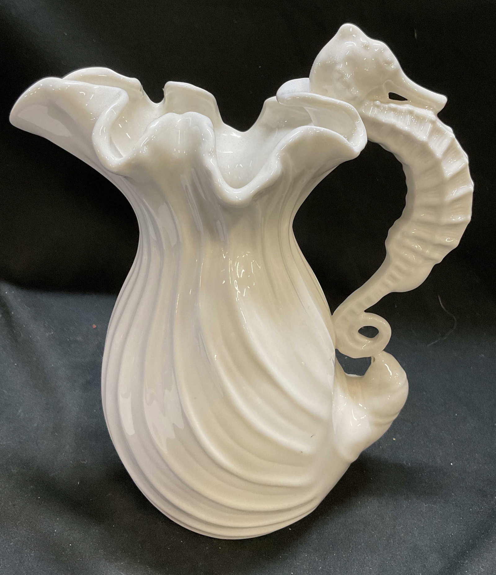 Kaldun & Bogle Majolica-Style Seahorse Pitcher: Kaldun & Bogle Majolica-Style Seahorse Pitcher. Ruffled ridged seashell design with seahorse handle. Condition consistent with age and exposure. Measures app 9in H x 7in Diam. Kaldun & Bogle, majolica