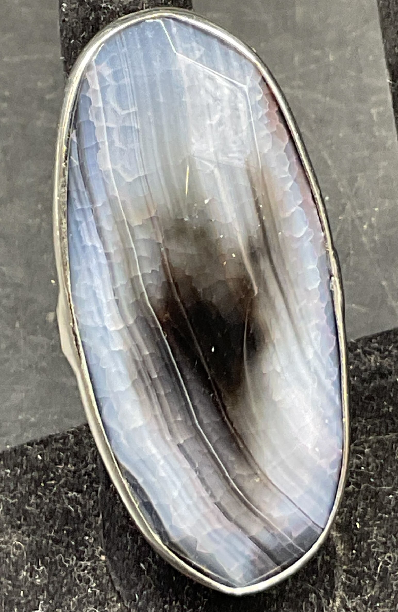 Vintage Semiprecious Gemstone Statement Ring: Vintage semiprecious gemstone statement ring. Tested with Presidium Gem Tester II. Oval shaped with silver toned band. Blue and black faceted gemstone. Measures approx size 9. Scratching. Jewelry,