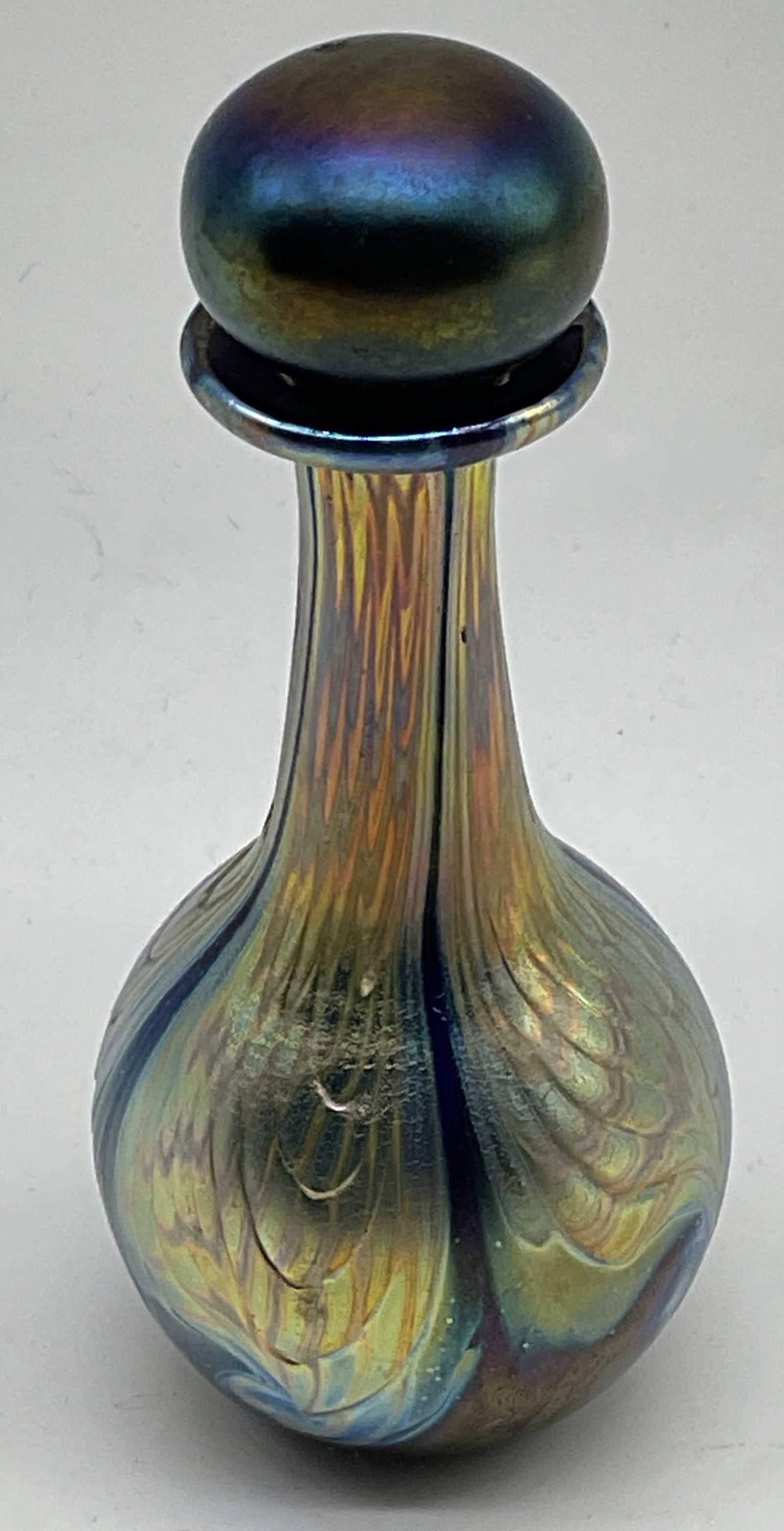 93 Signed Studio Art Glass Perfume Bottle: Vintage 1993 Signed Studio Art Glass Perfume Bottle with Stopper. Signature reads illegibly. Iridescent combed wave pattern in gilt, amber, blue, and purple over cobalt base. Condition consistent
