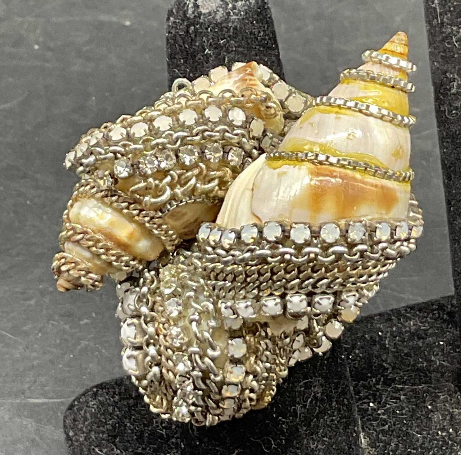 Vtg Erickson Beamon Shell & Rhinestone Ring: Vintage Erickson Beamon shell and rhinestone ring. Surface marked Erickson Beamon. Silver toned band. Two distinct cream and orange striped shells. Accented with link cords. Clear and white rhinestone