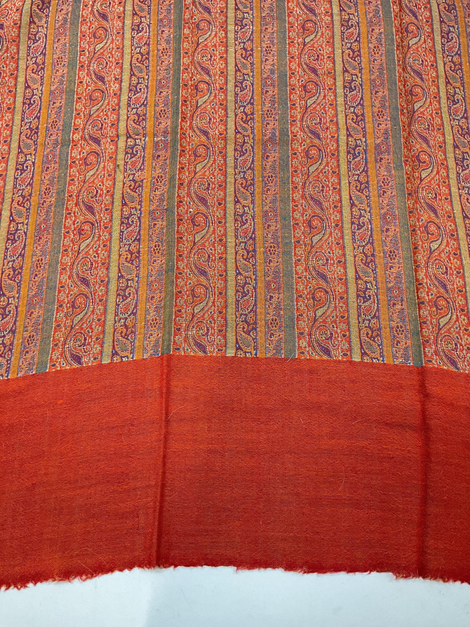 Vntg paisley patterned shawl: Vintage paisley patterned shawl. Showcases an earthy color way dominated by brick orange , Burt sienna, olive gold, contrasted with steel blue and grey at the border. Features dense stripes of repeati