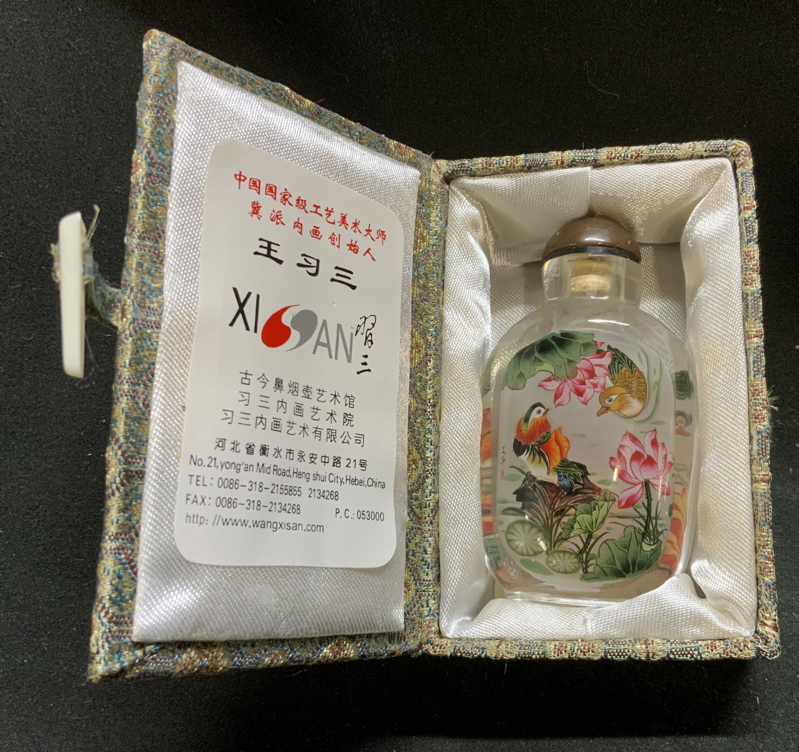 Chinese Wang Xisan Studio Inside-Painted Glass: Snuff Bottle Chinese Wang Xisan Studio Inside-Painted Glass Snuff Bottle in Original Presentation Box. Includes snuff spoon. Hand-Painted by student at academy. Varying birds motif on both sides. Cond