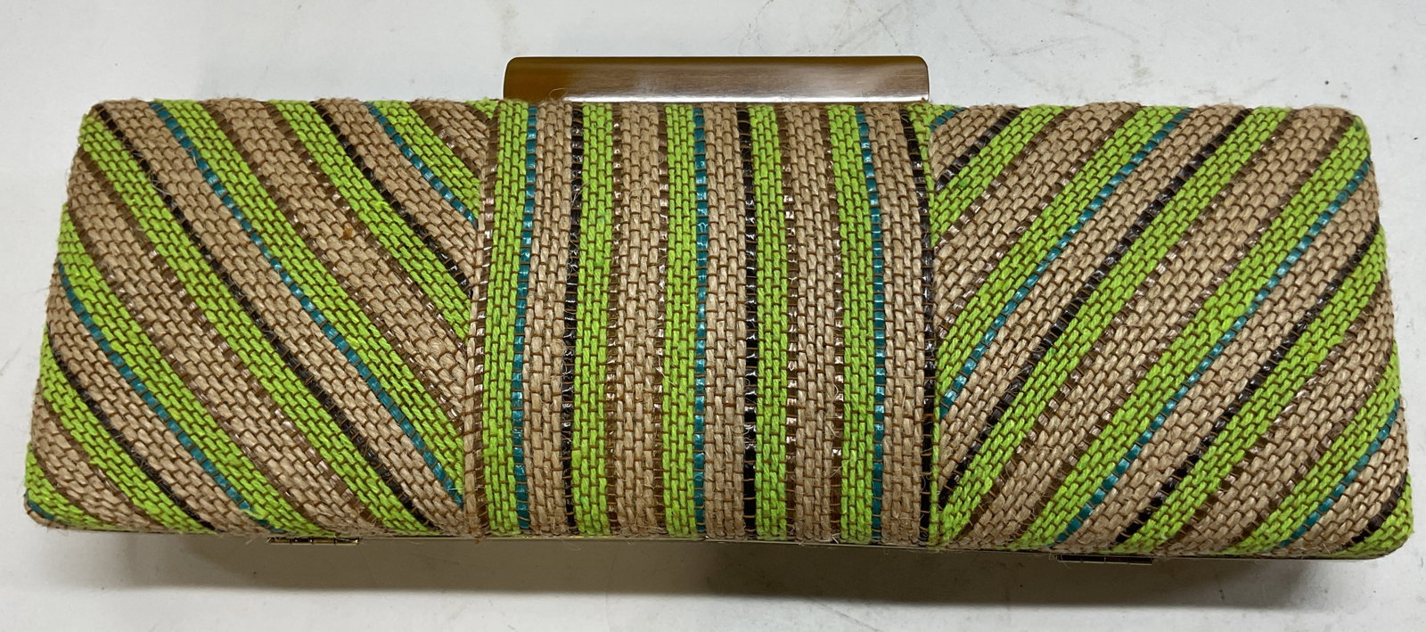 Carmen Marc Valvo Jute Pattern Hardcase Clutch: Carmen Marc Valvo jute pattern hardcase clutch. Rectangular shape. 100% jute. Attached chain strap. Diagonal and vertical striped lines, brown blue green black. Gold toned frame. Interior compartments