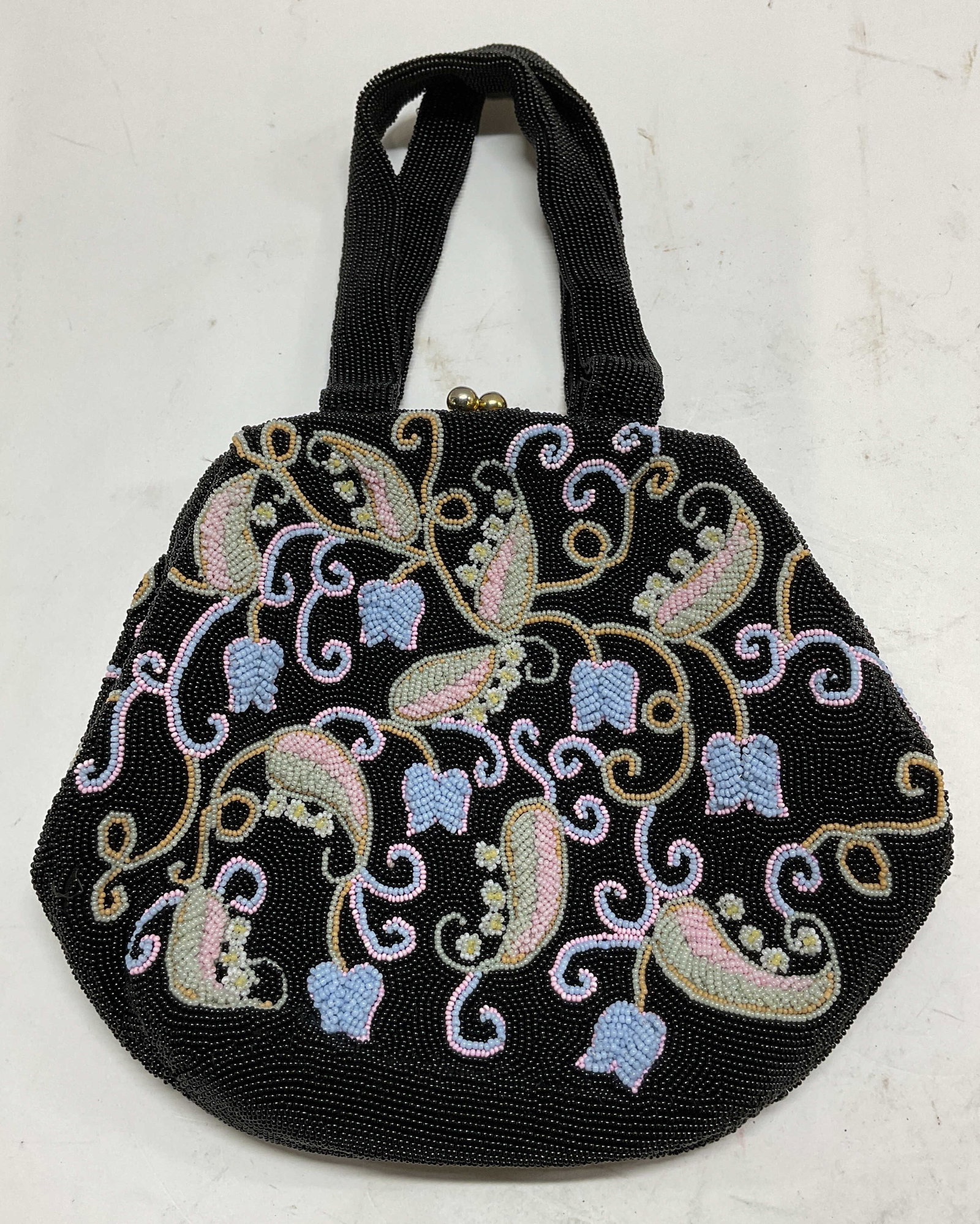 Saks Fifth Ave Blk Beaded Evening Handbag Belgium: Saks Fifth Ave black beaded evening handbag. Interior reads Made In Belgium Exclusively For Saks Fifth Ave. Attached beaded straps. Beaded floral and scroll pattern in varying colors. Interior compart