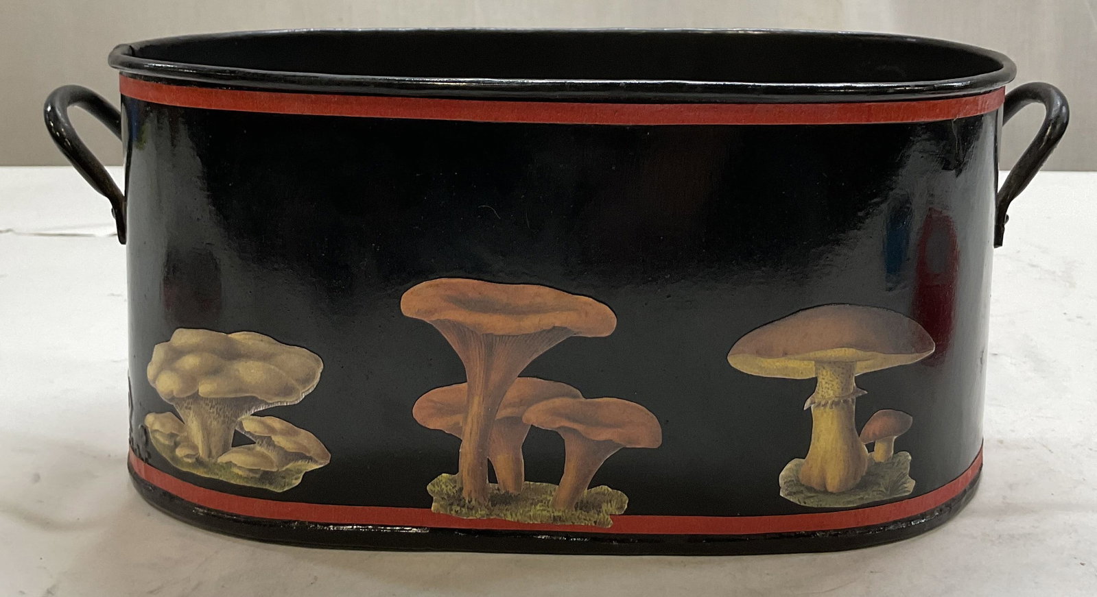1994 SGND Turkart Metal Toleware Planter: Signed Turkart metal toleware planter. Surface marked Turkart. Signed on underside, dated 1994. Oval shaped planter with handles on either side. Top and bottom red stripe accent border. Various mushro