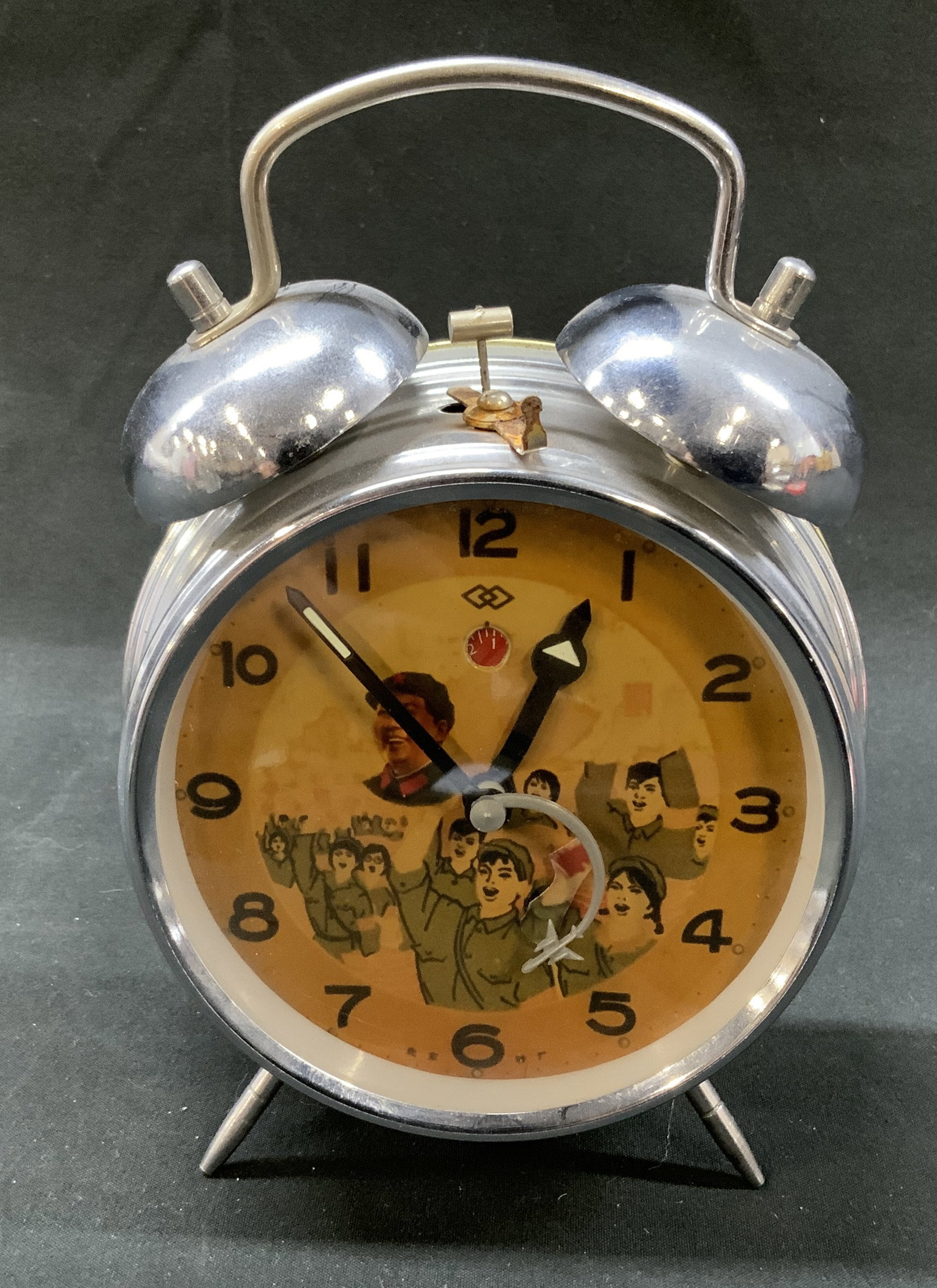Chinese Revolution Twin-Bell Alarm Clock: Quotations From Chairman Mao Chinese Alarm Clock Chinese cultural revolution style porcelain vase. Showcasing Chinese propaganda illustrations. Traditional round analog dial face, chrome plated metal 