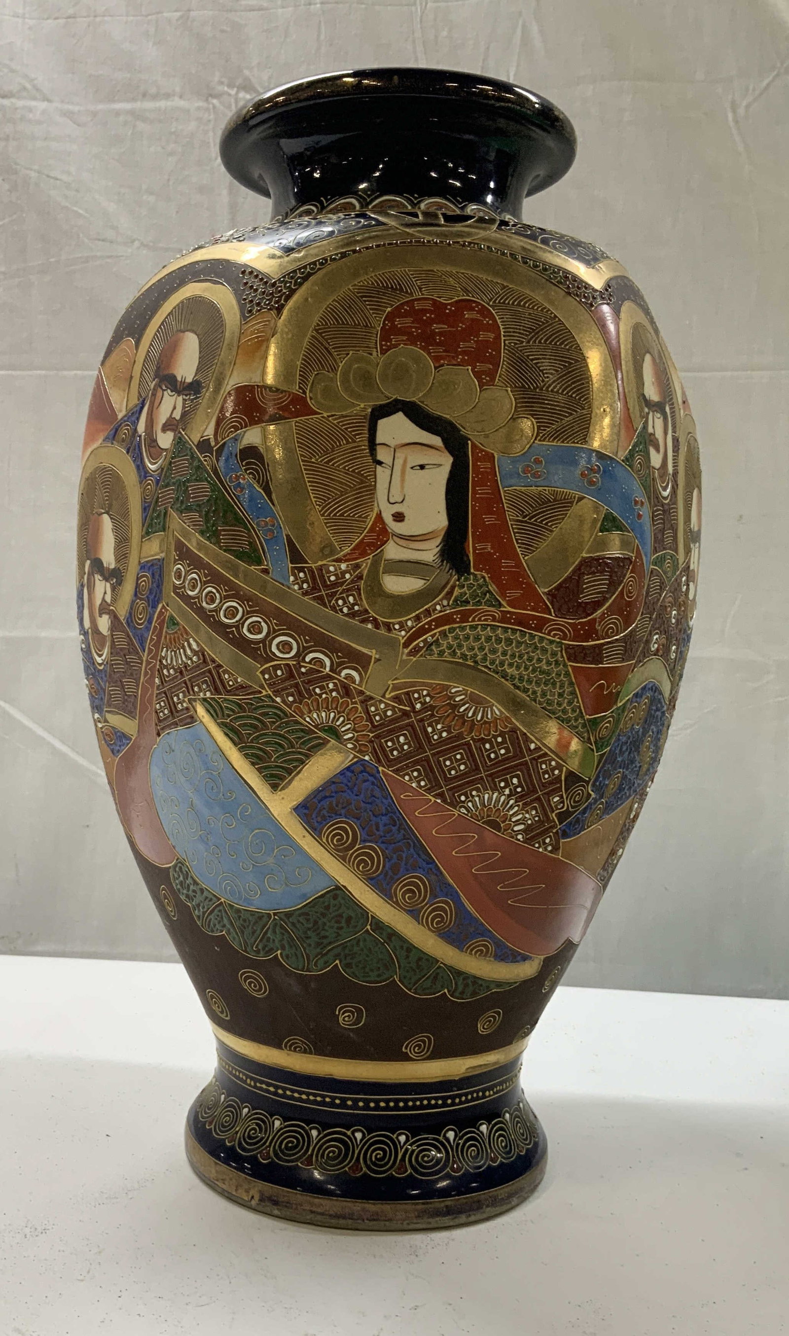 Vntg Japanese Satsuma hand painted vase: Vintage Japanese Satsuma hand painted vase. Made in Japan stamped on the bottom. Polychrome and heavily gilded hand painted figures against a dark blue background with gold scroll work. The figures ar