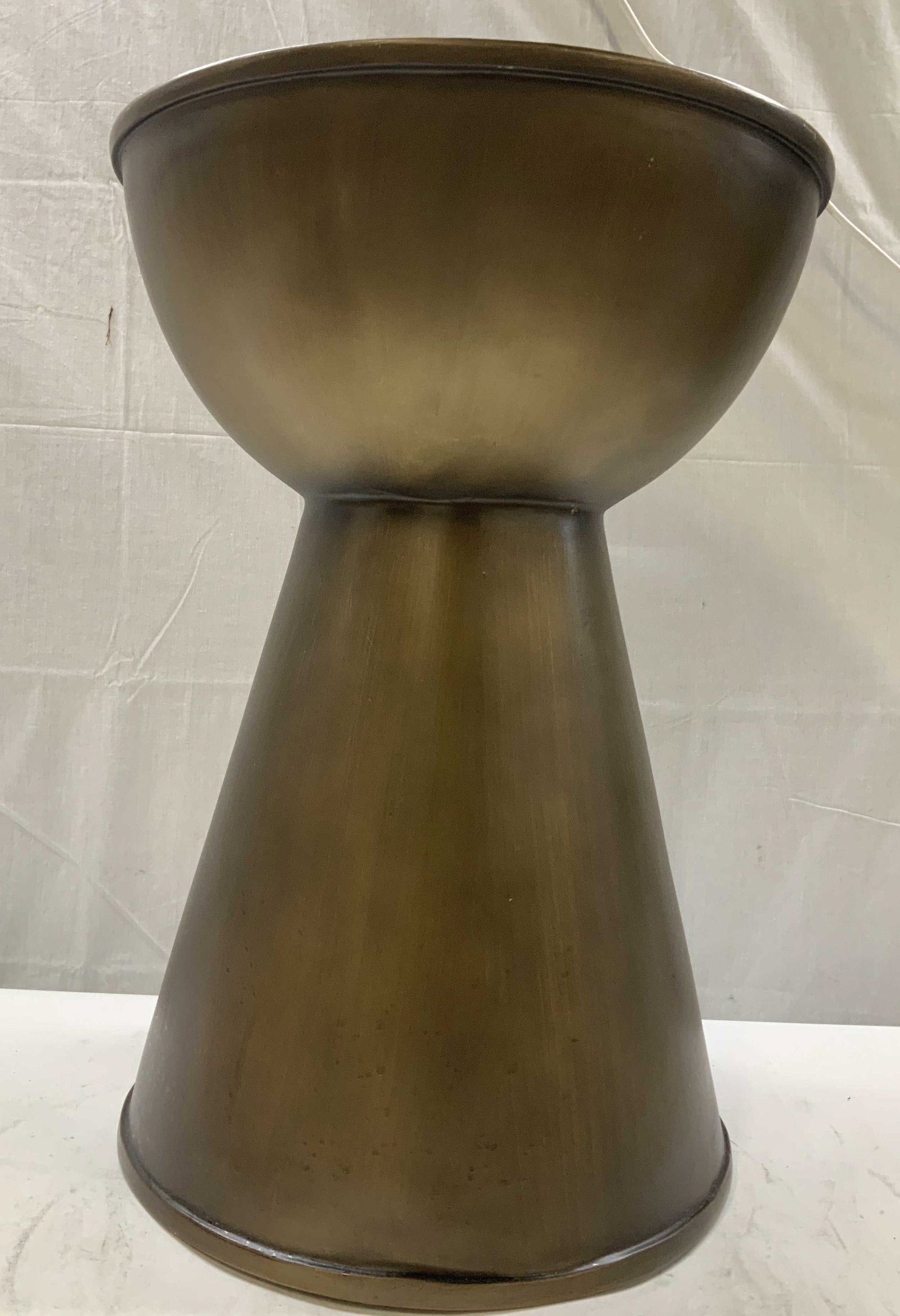 MADISON PARK Alber accent table: MADISON PARK Alber accent table. It is an hourglass shaped drum table. Most metal styles are cast from sheet aluminum, the Madison Park version is constructed from a durable resin base finished in a