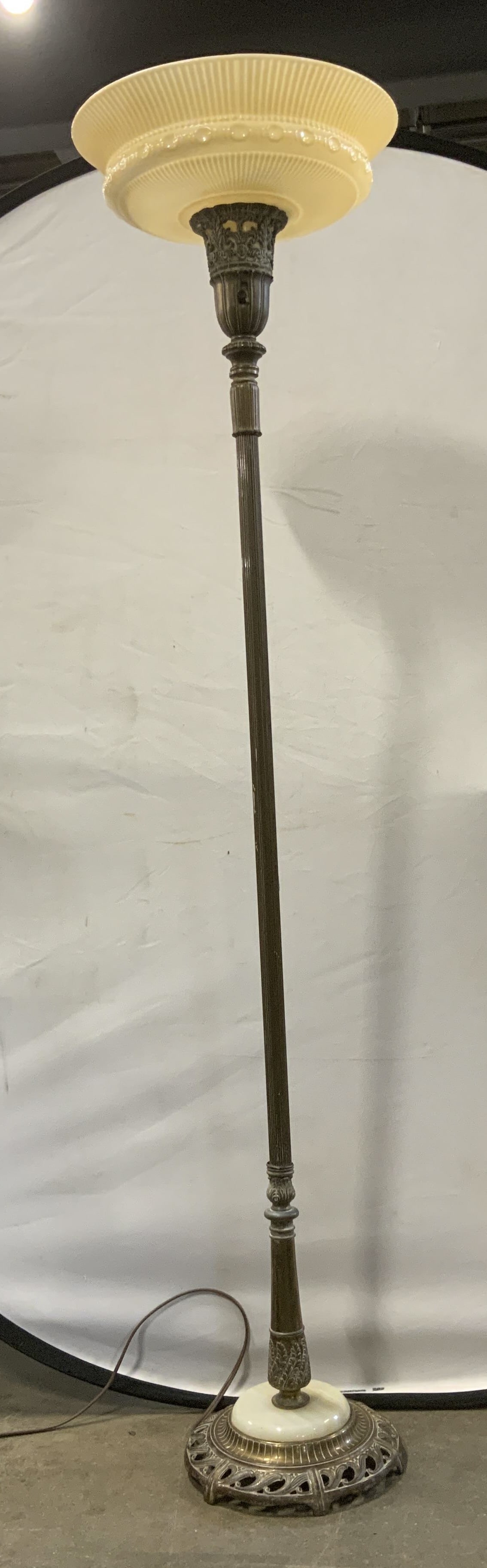 Vintage Art Deco Torchiere Floor Lamp: Vintage Circa 1920s-1940s Art Deco Torchiere Floor Lamp. Flared custard-colored glass bowl shade with fluted pattern and embossed detailing. Decorative filigree cast-metal sconce holder. Slender colum
