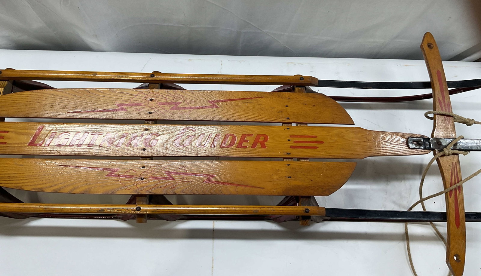 Vntg Lightning Glider? wooden snow sled, USA: Vintage Lightning Glider wooden snow sled. Made in the USA, produced by Standard Novelty Works in Pennsylvania. Made of vanished wood slates with red graphics and a painted metal runner frame. Include