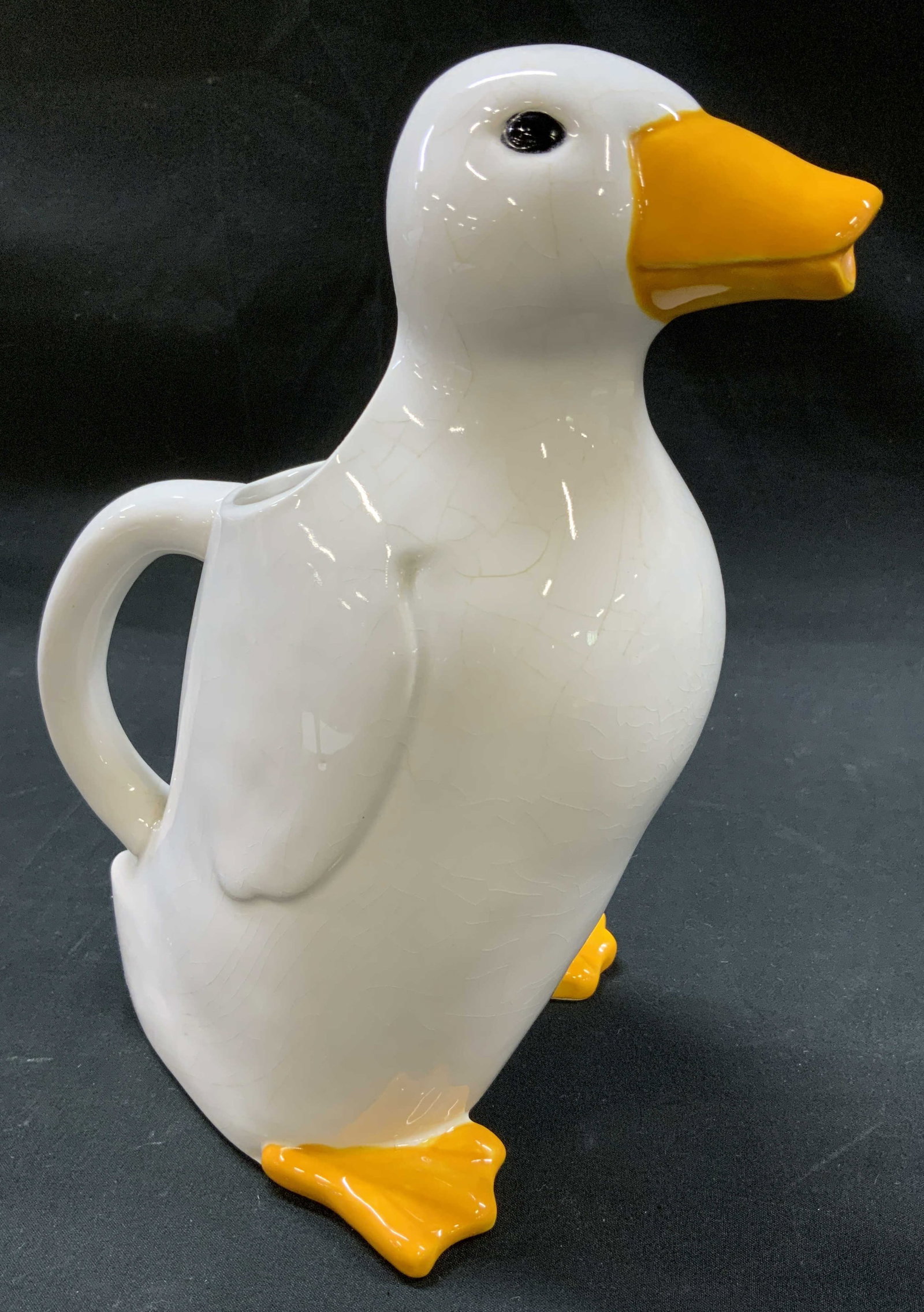 Vtg Figural Ceramic Duck Spout Pitcher: Vintage ceramic pitcher sculpted in the shape of standing white duck. Orange beak functions as spout, matching orange webbed feet and hand painted black eyes. Integrated handle on back. Condition