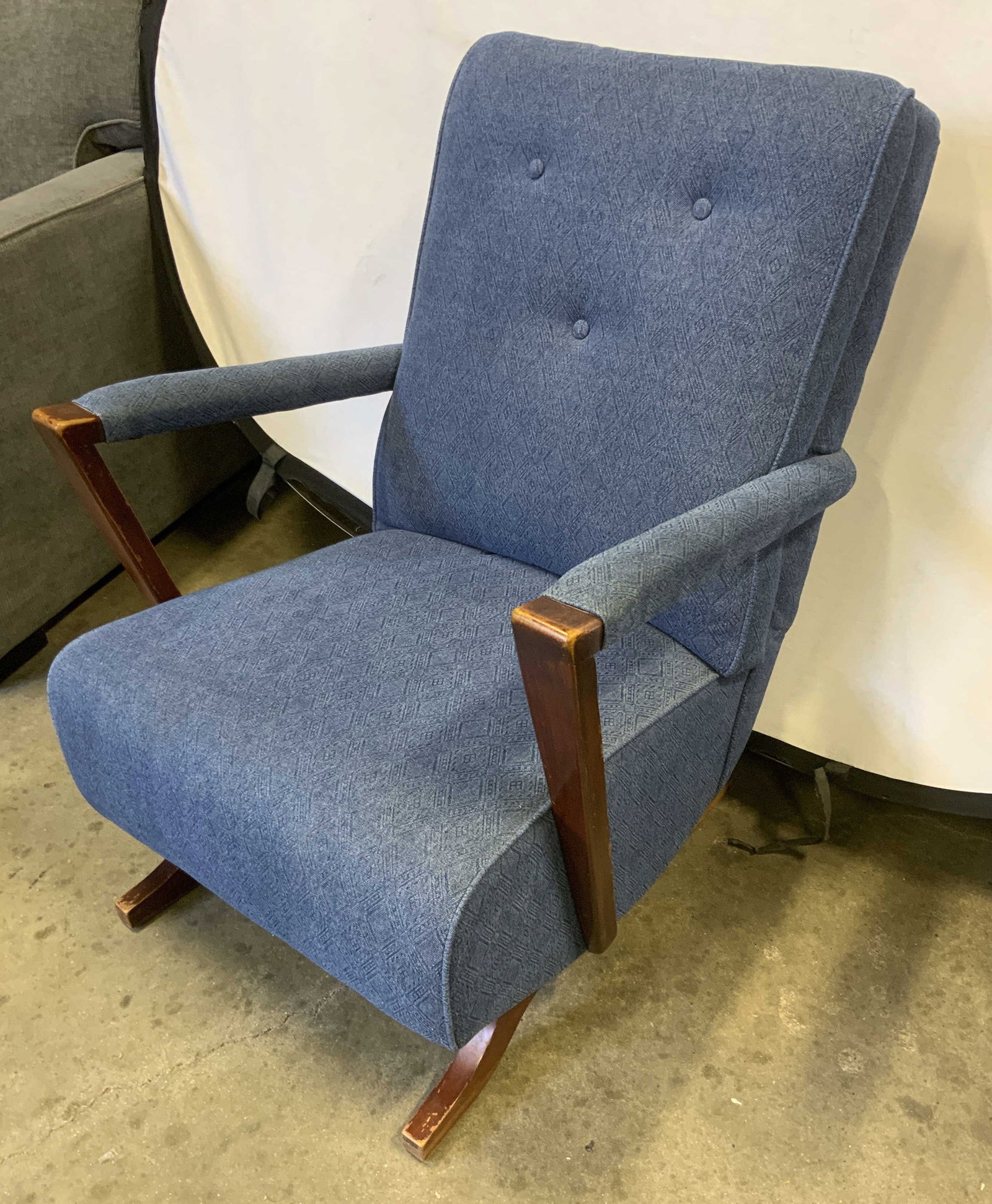 Vtg Blue Upholstered Platform Rocking Chair: Vintage Upholstered Platform Rocking Chair. Dusty blue fabric with diamond textured pattern. Soft cotton blend material. Button-Tufted accents. Slanted reddish-brown stained wooden armrests. Some