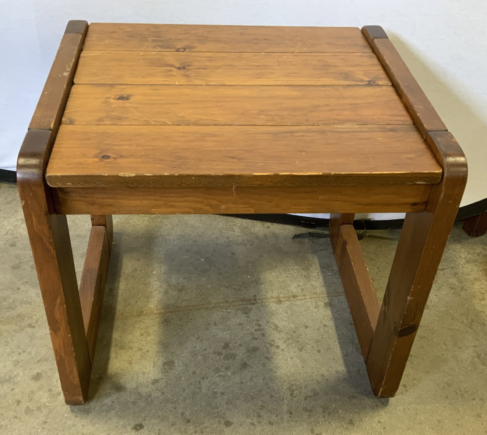 Vtg Mid-Century Brutalist Pine Side Table: Vintage Mid-Century Circa 1970s Brutalist Pine Wood Side Table. Thick unadorned planks. Chunky rectangular block legs. Exposed metal peg detailing. Scratching present. Measures app 20in H x 22.5in L