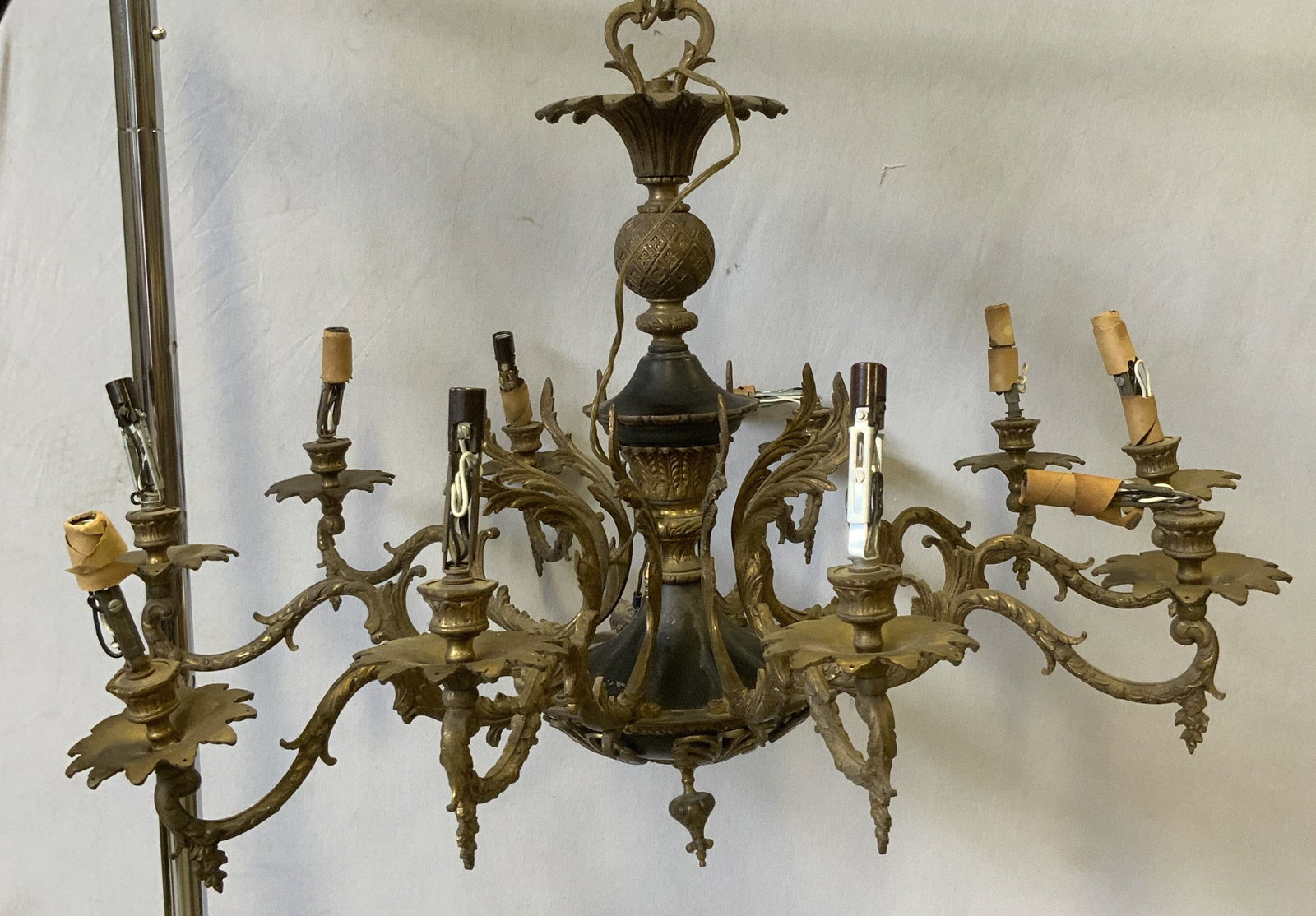 Vtg Rococo Style Cast-Brass Chandelier: Vintage Circa 1960s-1970s Rococo Style Patinated Cast-Brass Chandelier. 10 scroll arms. Acanthus leaf accents. Finial vase body. Bending and aging to metal present. Not tested for functionality. Measu