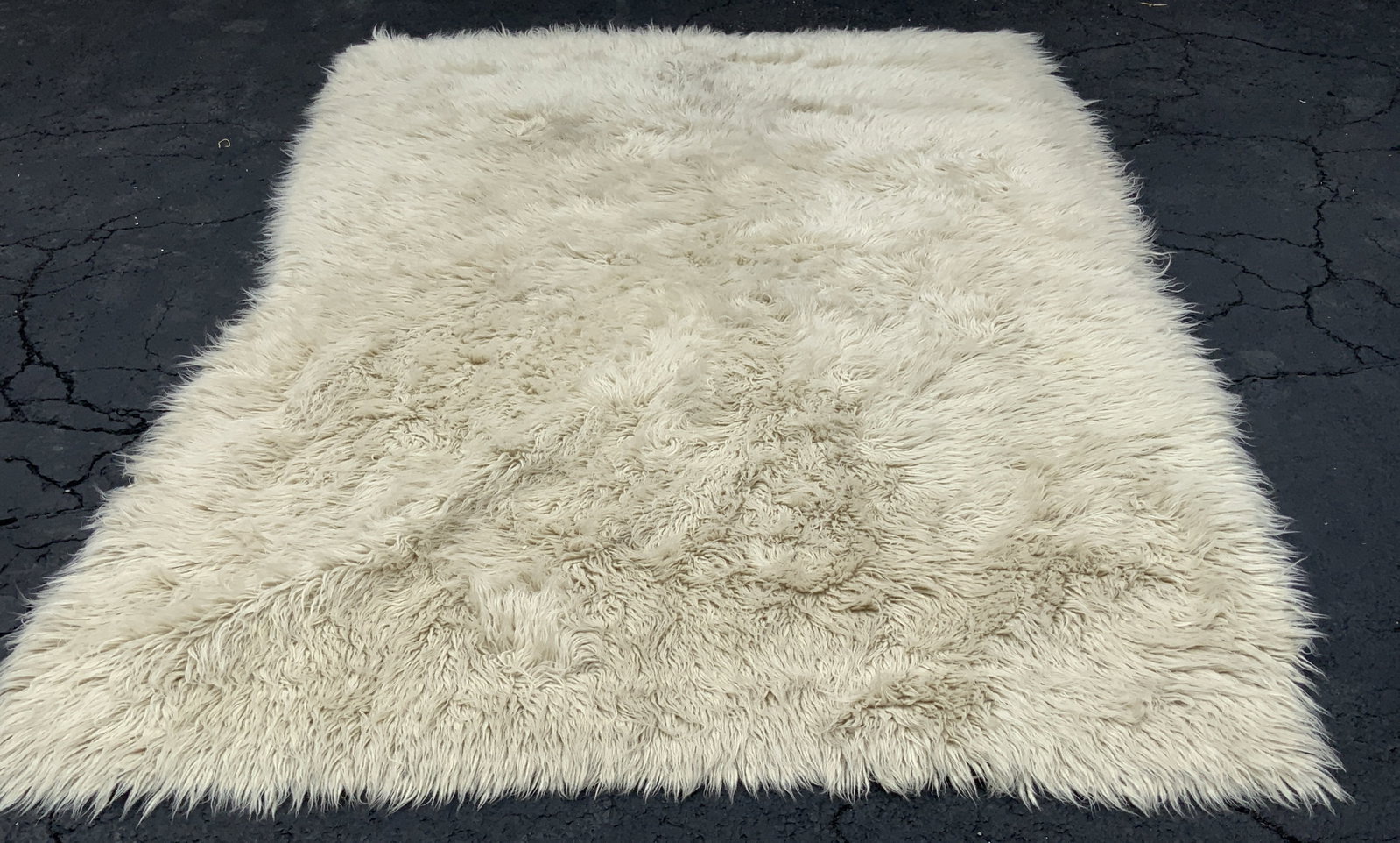 Pure New Wool Greek Flokati Rug Greece: Pure new wool Greek Flokati rug. Made in Greece. Tag on underside as photographed here. Pure new wool material. Thick white shaggy texture. Measures approx 70 x 100 inches. Surface wear consistent