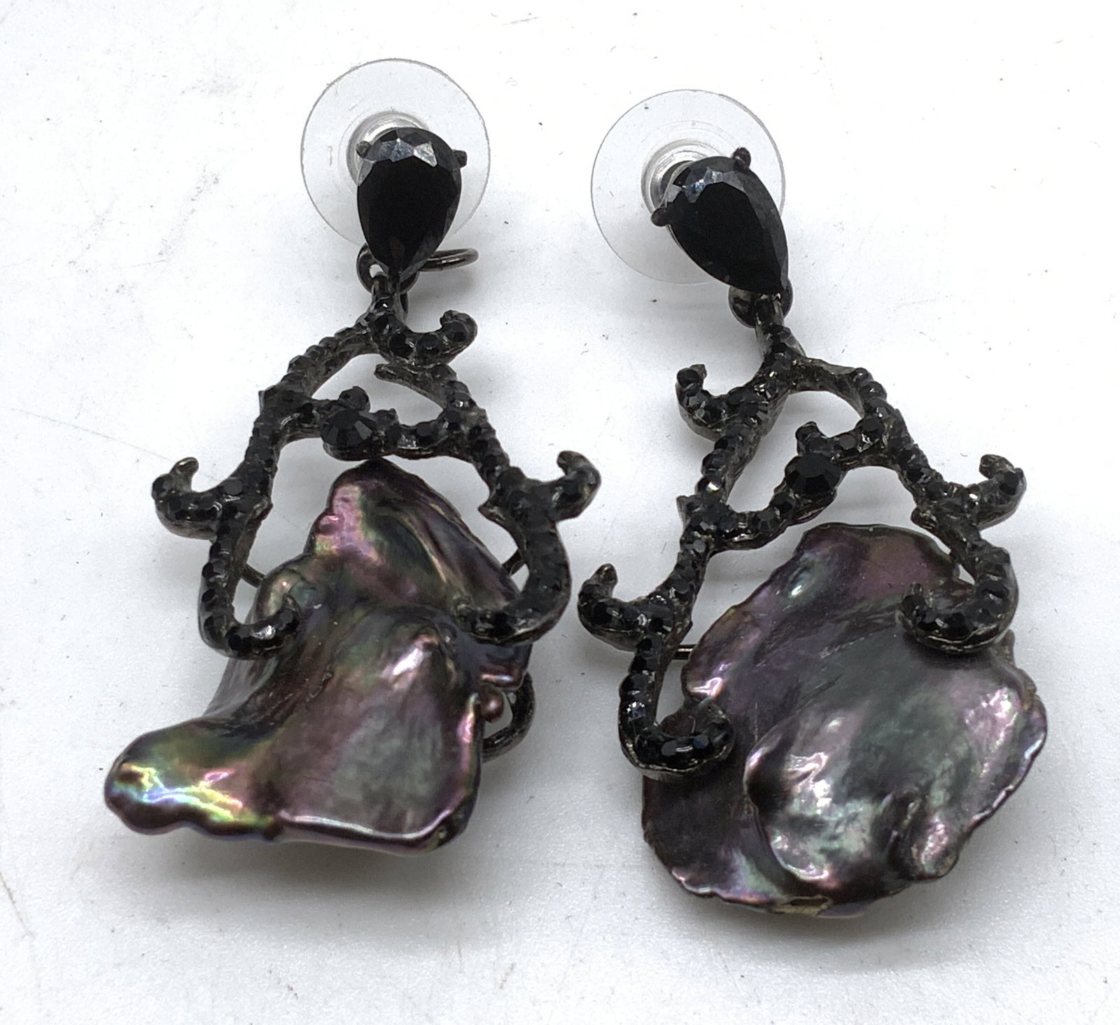 Signed Siman Tu Genuine Keshi Pearl Earrings: Signed Luxury Siman Tu Genuine Flat Peacock Keshi Pearl Clip-On Earrings. Ornate silver-toned branch work pave set with black crystals. One missing brand tag on back. Measures app 2in H. vintage earri