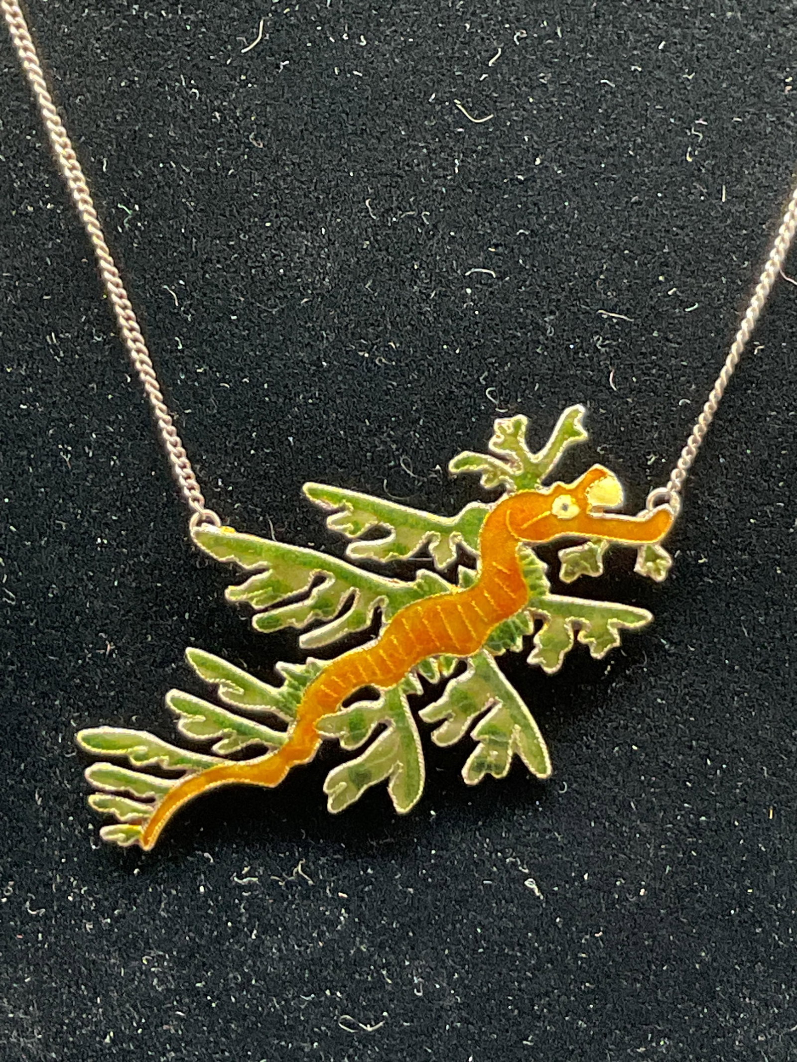 Vtg Sterling Silver Enamel Sea dragon Necklace: Vintage sterling silver enamel sea dragon necklace. Clasp marked 925. Red semiprecious gemstone on end of chain, Tested with Presidium Gem Tester II. Enamel sea dragon figure, orange and green. Total 
