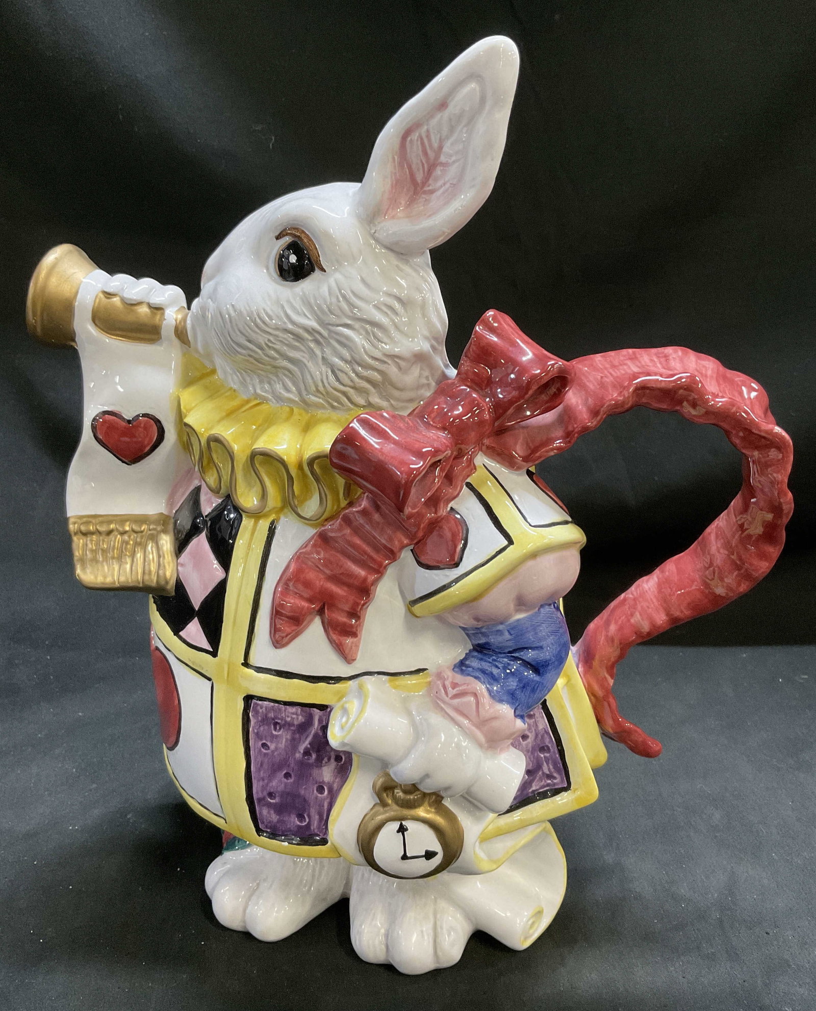 92 Fitz & Floyd Wonderland White Rabbit Pitcher: Vintage 1992 Fitz & Floyd Alice in Wonderland White Rabbit Ceramic Pitcher. Harlequin-Patterned jacket. Red bow handle. Blowing horn. Condition consistent with age and exposure. Measures approx