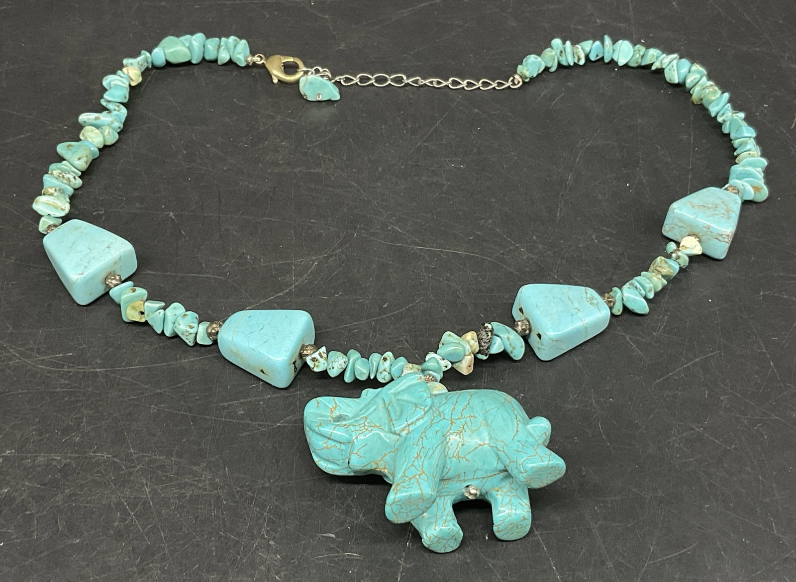 VTG HDNY Turquoise-Toned Elephant Necklace: Vintage Henry Designs of New York Necklace. Turquoise-Toned natural stone. Features elephant pendant with trapezoid and nugget shaped stones. Condition consistent with age and exposure. Measures