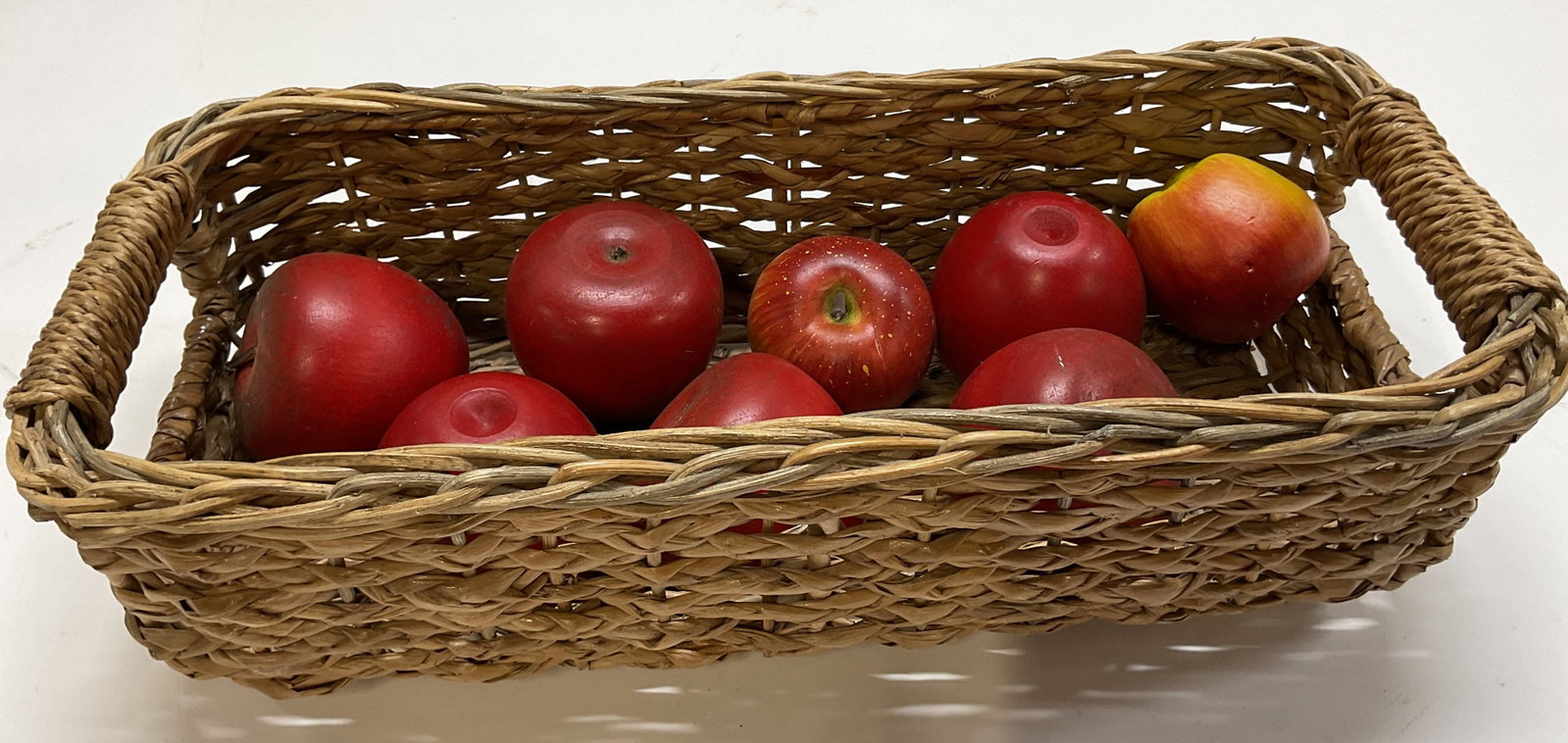 Vtg Rectangular Woven Basket W Decorative Apples: Vintage rectangular woven basket. Rectangular shape. Handles on either side. Woven braided design. Comes with 8 decorative apples, wood and paper mache. Red with brown stem, hand painted. Basket measu