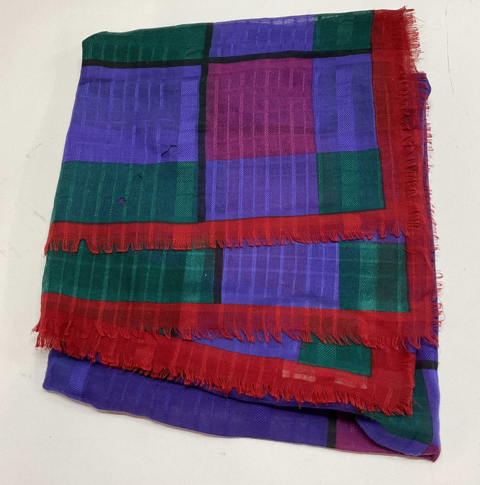 Vtg Multicolor Geometric Sheer Fringed Scarf Italy: Vintage multicolor geometric sheer fringed scarf. Made in Italy. Red fringed trim. Geometric pattern in red, purple, black, pink, and green. Measures approx 52 x 54 inches. Holes. Property of Upper