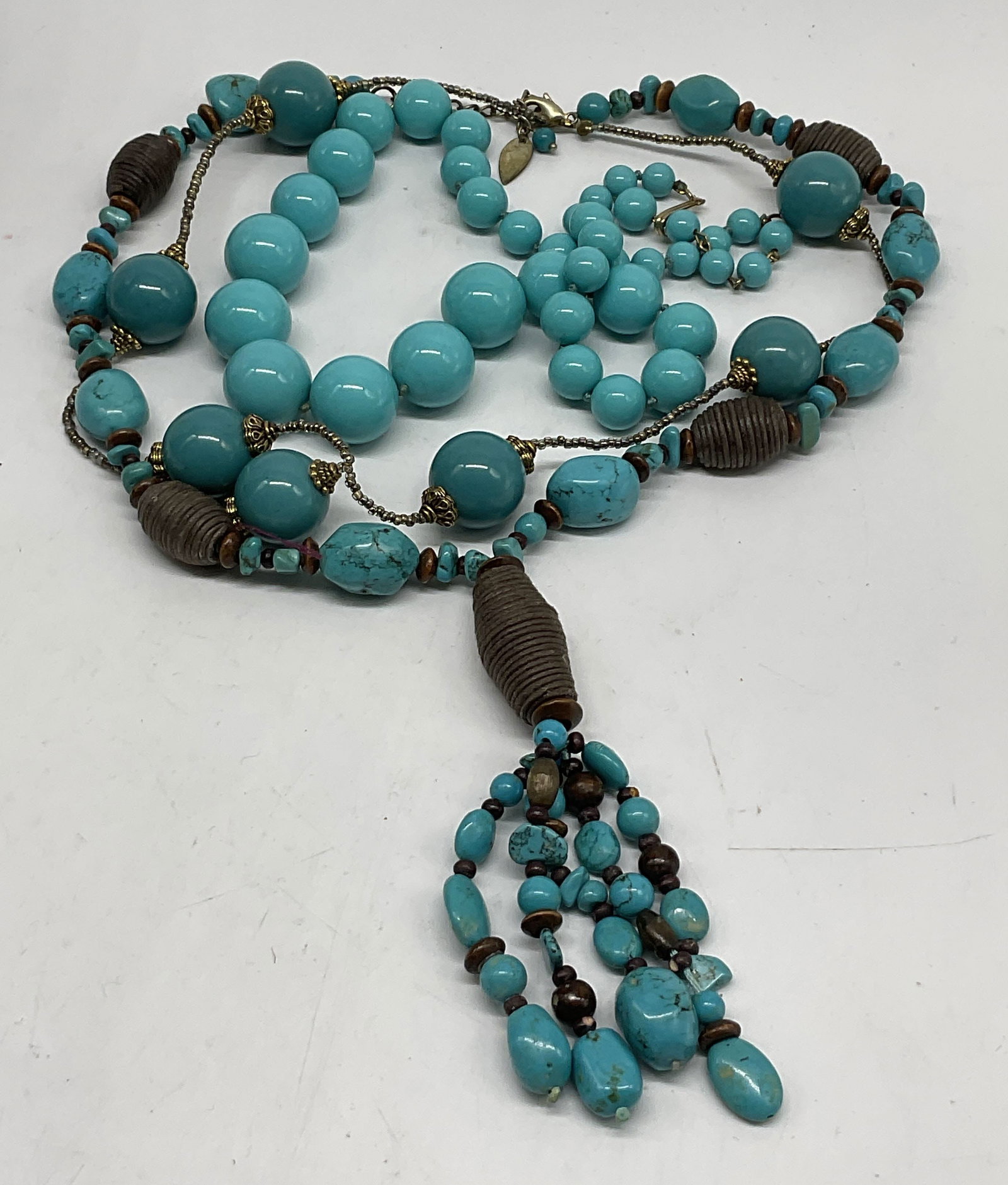 Lt3 Turquoise Toned Necklaces: 3 Turquoise Toned Necklaces. Includes a Coldwater Creek dyed-howlite beaded necklace with coiled rope and wooden beads, a beaded necklace with round glass beads and metallic seed beads, and a chunky g