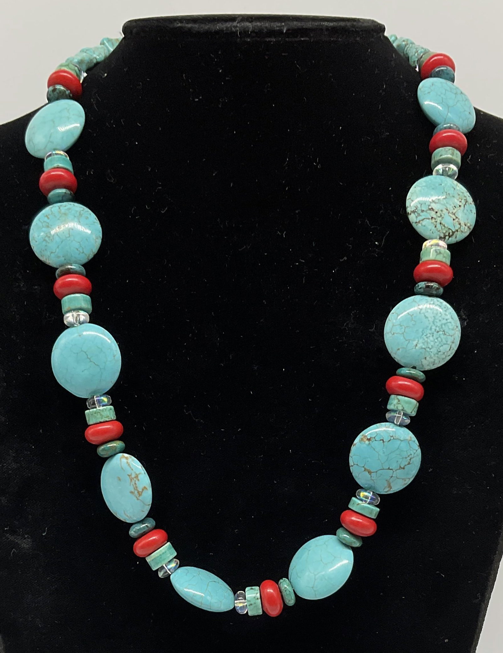 Southwestern-Style Turquoise-Toned Disc Necklace: Southwestern-Style Turquoise-Toned Natural Stone Necklace. Turquoise Discs and Nuggets. Red Coral Style Rondelles. Toggle Clasp. Condition consistent with age and exposure. Measures app 20.5in L.
