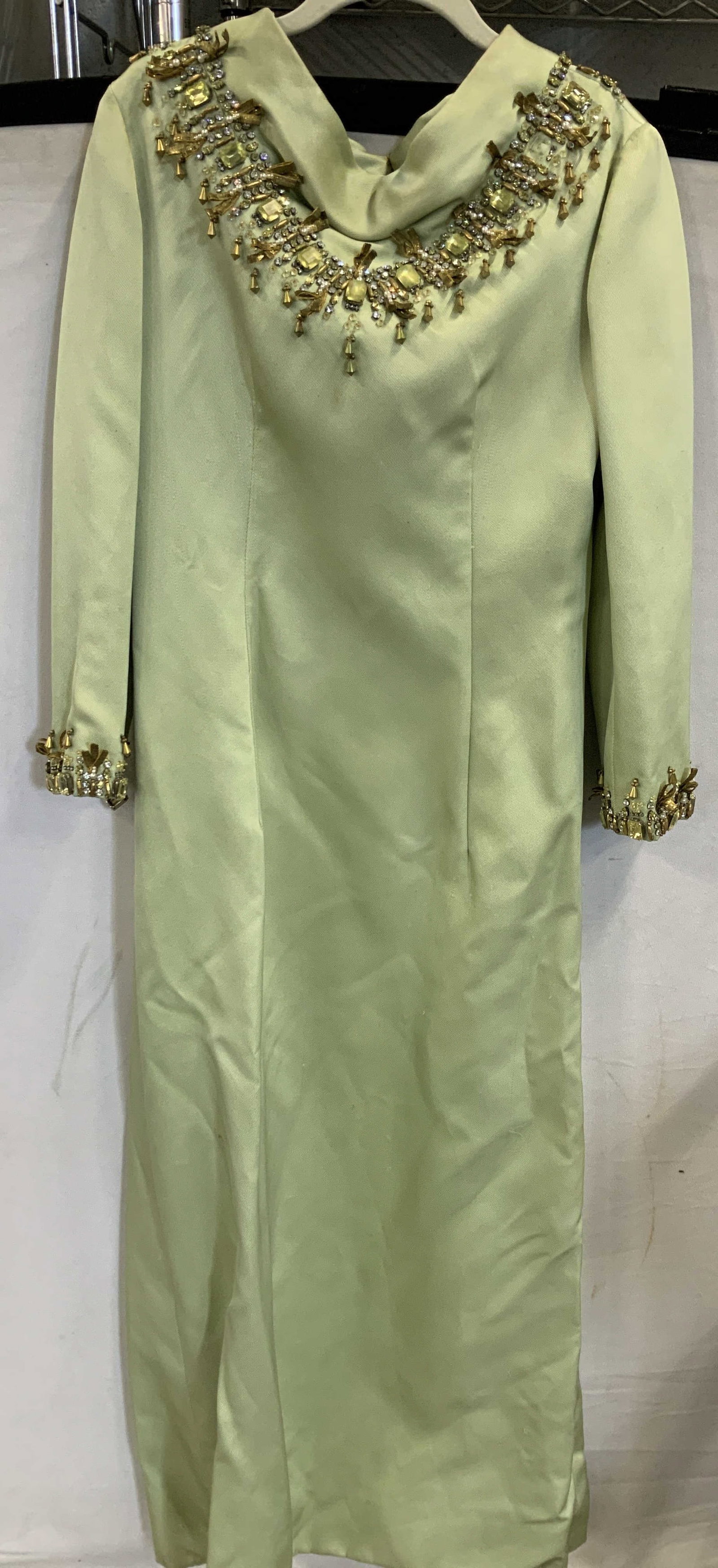 Vntg long sleeve evening gown: Vintage long sleeve evening gown. Features a sage green color, crystal and rhinestone embellishments along the collar and cuffs. Has a zipper and hook closure. No size listed ,measures app 34 in chest