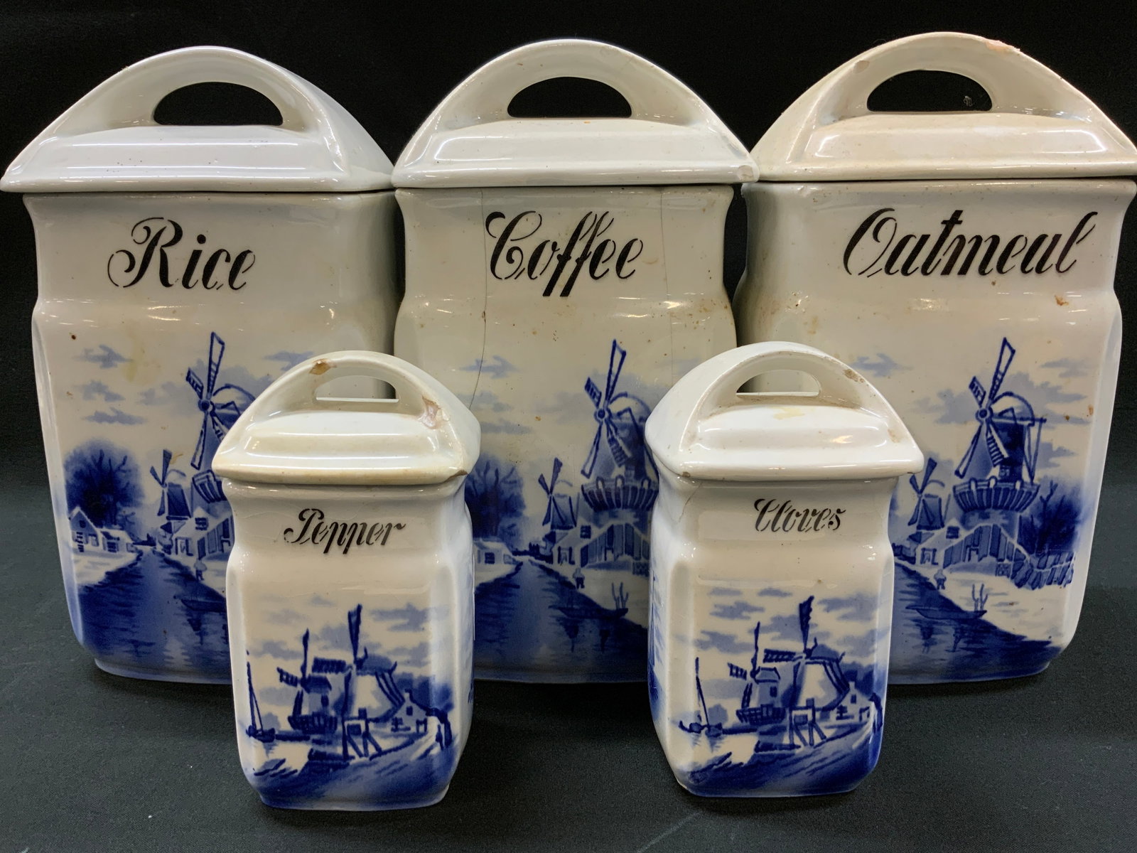 Lt5 Vtg Windmill Kitchen Canister Set, Germany: Lot of 5 vintage ceramic kitchen set. Blue and white Delft style Transferware design. Includes: 1x Rice 1x Coffee 1x Oatmeal large containers and 1x Pepper 1x Cloves small spice jars. Scenic Dutch lan