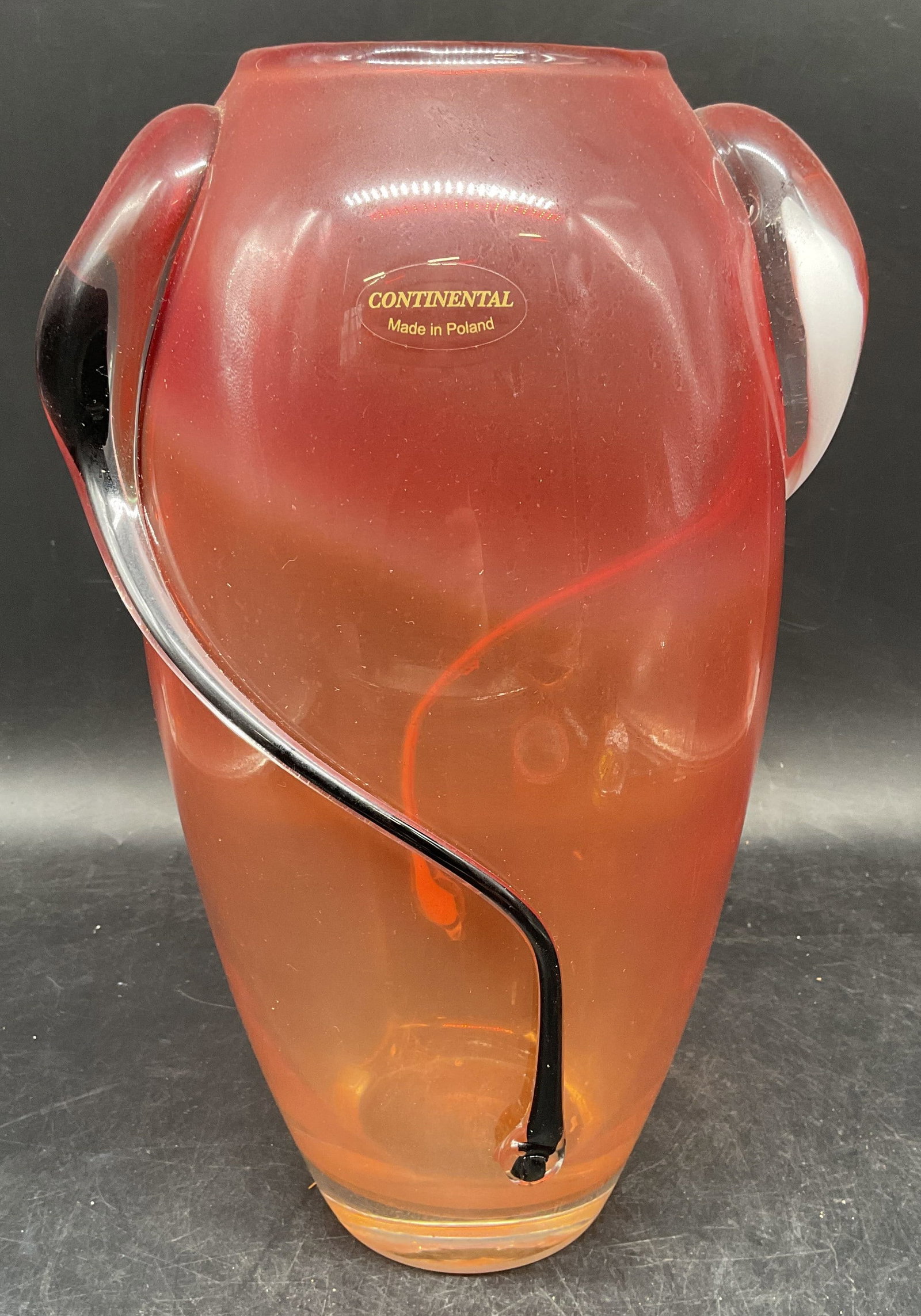 Vtg Continental Red Art Glass Vase, Poland: Vintage signed Continental hand blown art glass vase. Made in Poland. Cased red and clear glass with applies black and white curved decoration. Measures approx. 7.5 x 12 inches. Some scratching. Art
