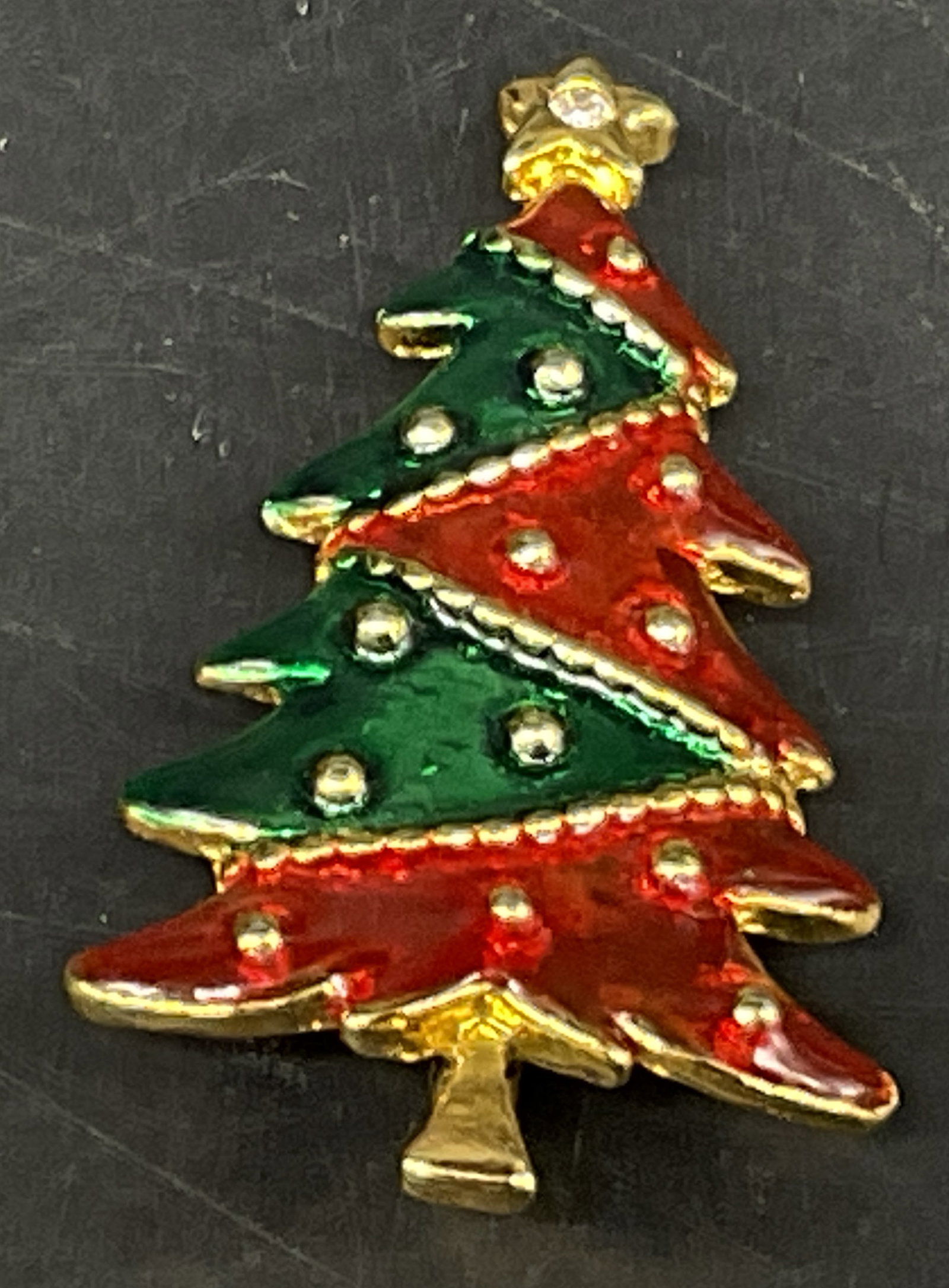 VTG AAI Multi-Tiered Enamel Christmas Tree Brooch: Vintage American Accessories Inc Multi-Tiered Christmas Tree Brooch. Gold-Toned with red and green cold-painted enamel panels. Star topper with rhinestone. Condition consistent with age and exposure.