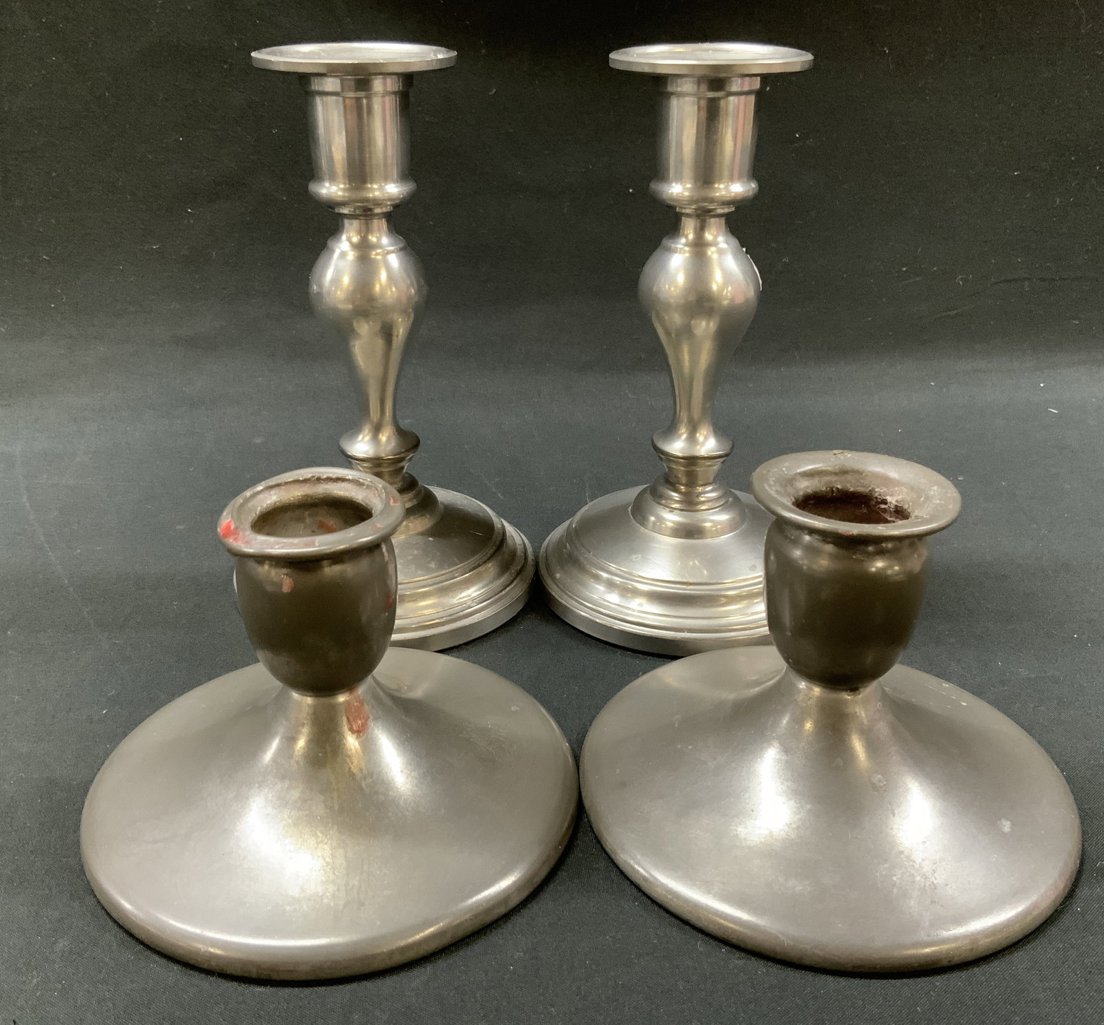 MxdLt4 Vtg Pewter Candlestick Holders: Mixed lot four piece vintage pewter candlestick holders. Includes 2x short candle holders marked Pewter by Rice on underside and 2x taller baluster stem candle holders with stepped round feet marked Q