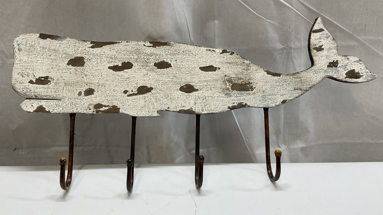 Vintage Wooden Whale Wall Hook Rack: Vintage wooden whale wall hook rack. Four metal hooks. Hand painted white, distressed look. Whale figure. Hooks on backside for mounting. Measures approx 5.5 x 28 inches. Chipping and loss to paint. W