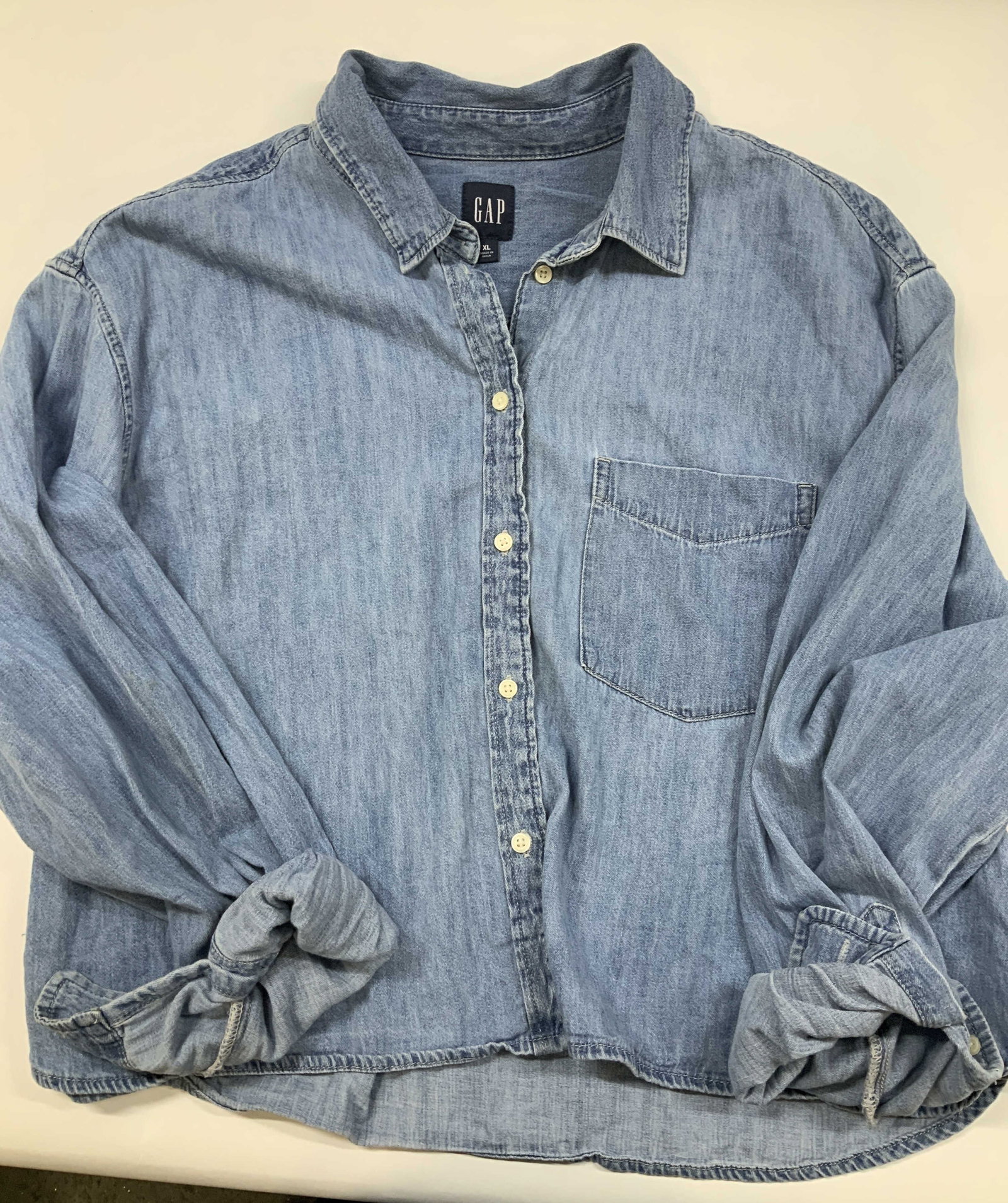 Gap denim crop shirt: Gap denim crop shirt. Made of 100% cotton is size XL. The Light wash button up balances Americana vibe with a modern silhouette. Features relaxed straight silhouette that drops into a cropped hem and 