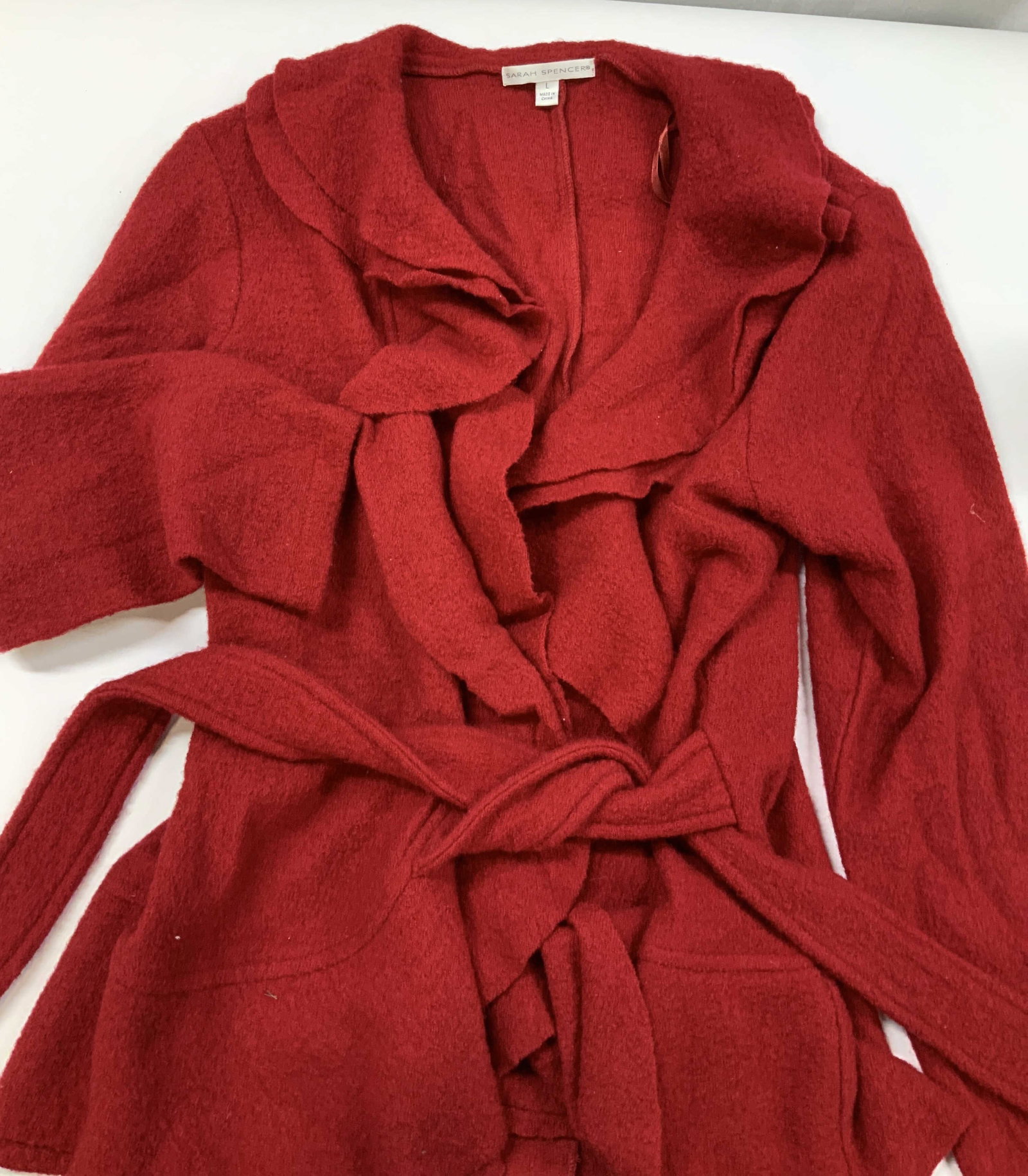 Vntg Sarah Spencer ruffle wrap wool cardigan: Vintage Sarah Spencer ruffle wrap cardigan. Made of 100% wool in a vibrant red color, size large. The neckline and open front feature heavy raw edge tiers of cascading ruffles that drape down the swea