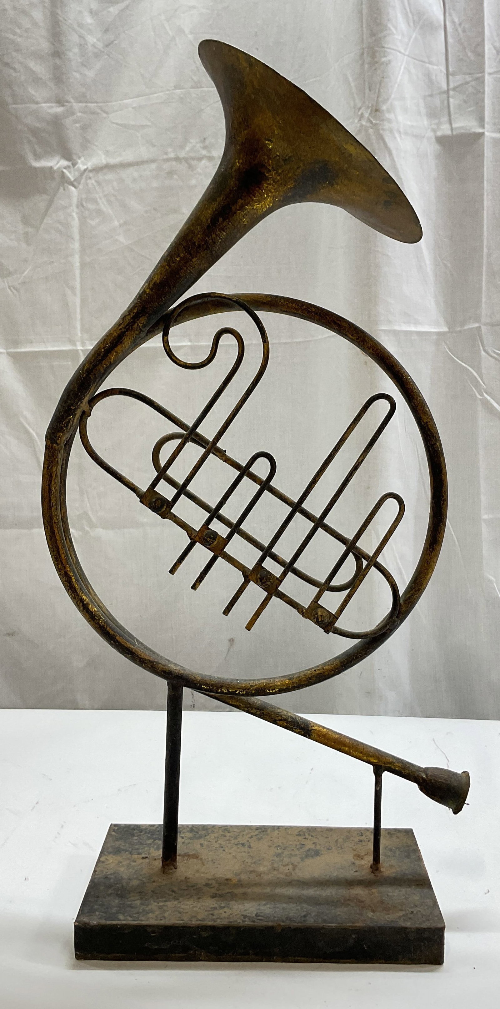 Vintage Metal French Horn Tabletop Sculpture: Vintage metal French horn tabletop sculpture. Rectangular base. Gilt finish. Horn sculpture, curved design. Measures approx 5 x 9 x 22.5 inches. Surface wear consistent with exposure. Sculpture, Frenc