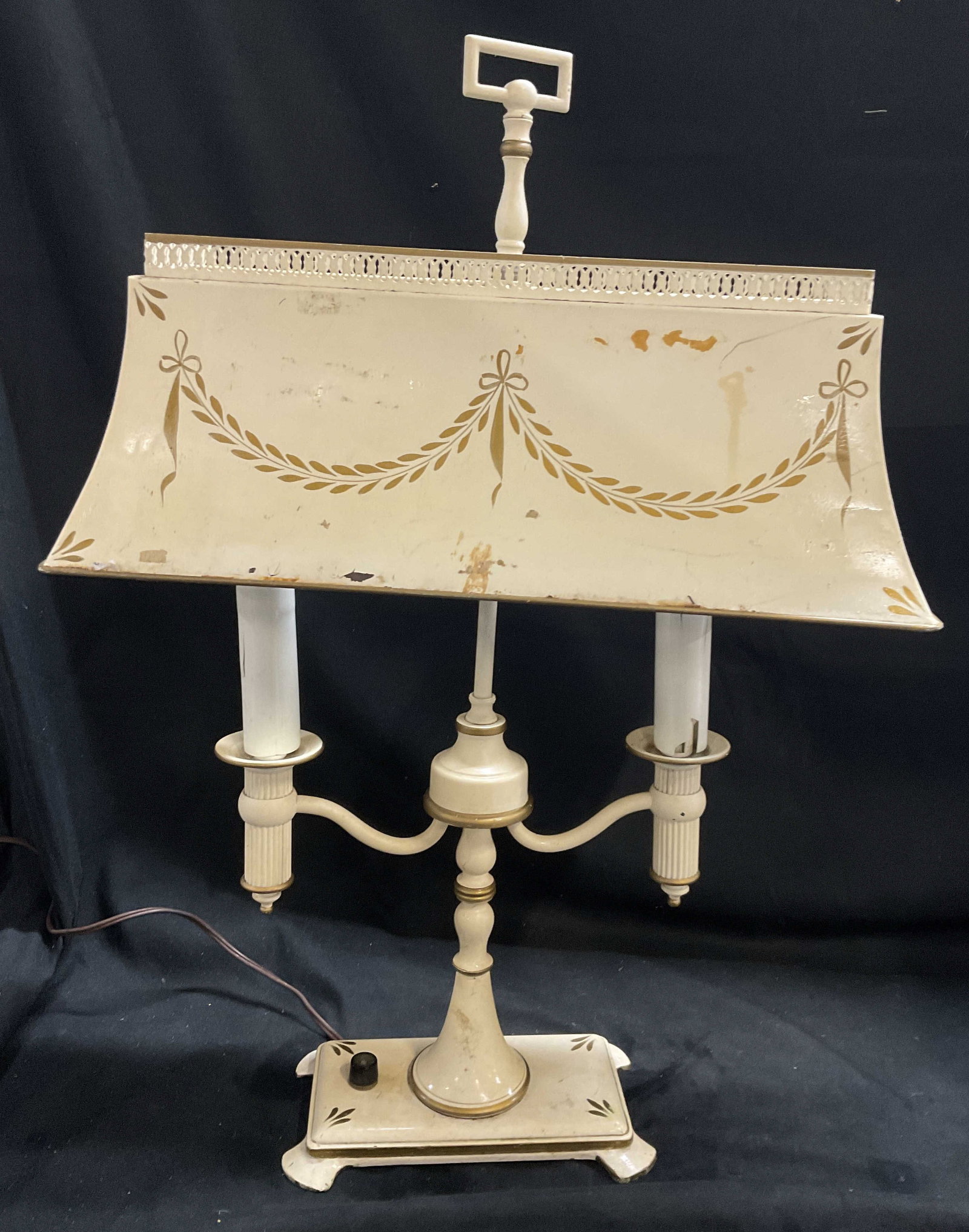 VTG French-Style Tole Bouillotte Table Lamp: Vintage Circa 1950-1970 French-Style Bouillotte Table Lamp. Toleware with cream base color and gilt laurel swags and bows. Two candle-style lights on scrolling arms. Chipping and aging to metal. Crack