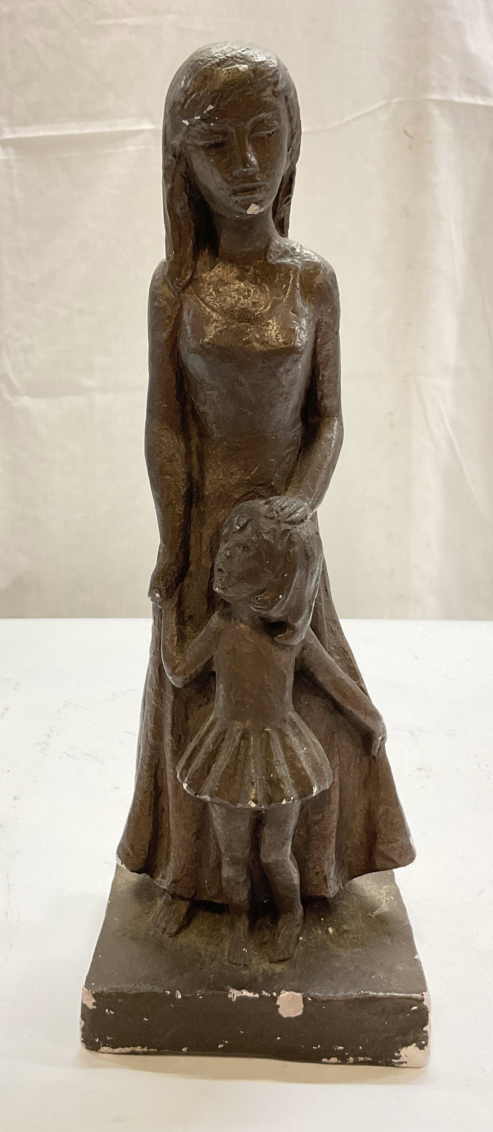 1967 Leonardo Art Works Mother & Child Sculpture: 1967 Leonardo Art Works mother and child chalkware sculpture. Marked Leonardo Art Works Inc on surface. Square base. Tall woman in a flowing dress holding the hand and head of a young child. Detailed 
