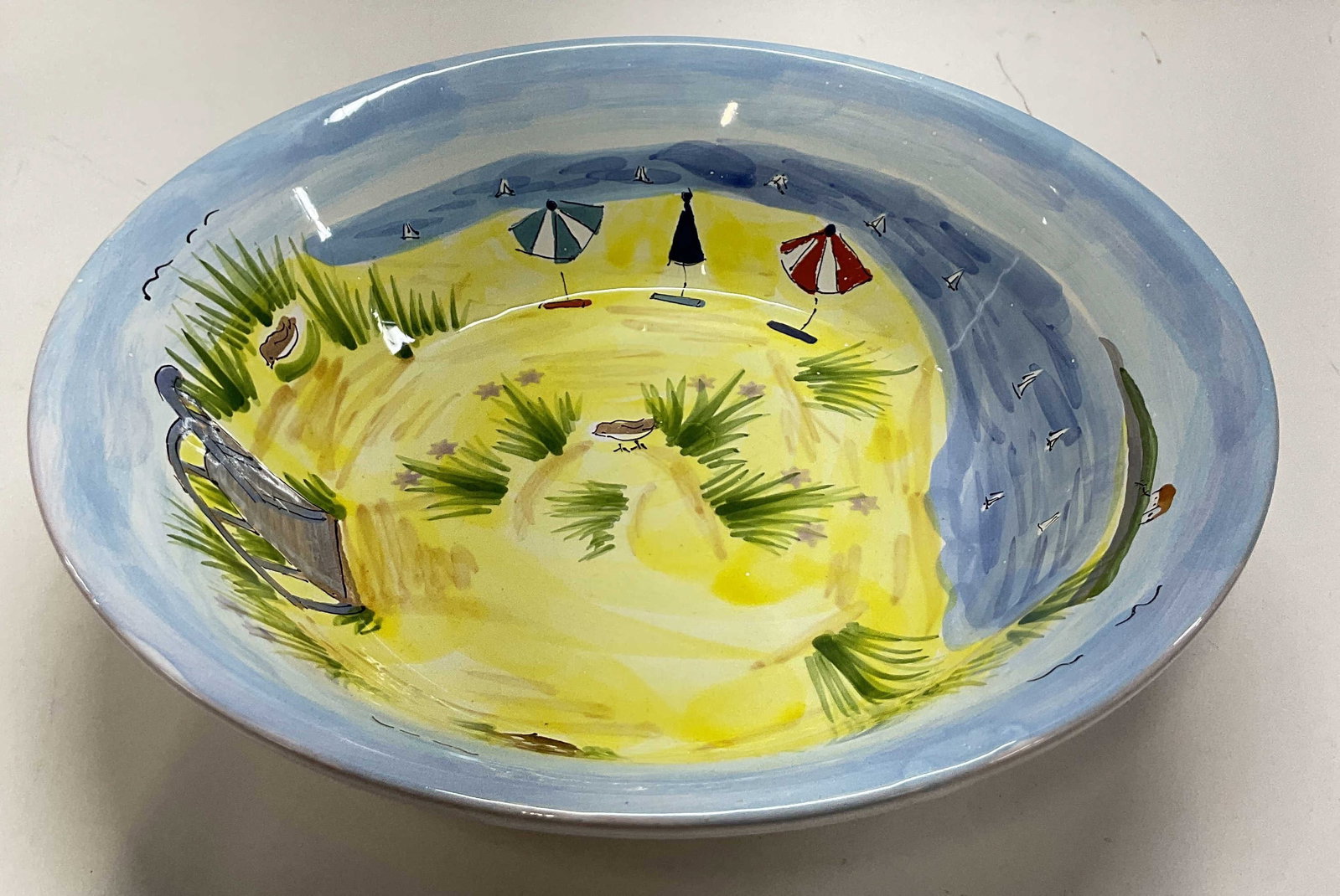 Mesa International Ceramic Serving Bowl Hungary: Mesa International ceramic serving bowl. Marked on underside, reads Handcrafted In Hungary Mesa International Warner New Hampshire. Wide round bowl. Hand painted beach scene featuring birds, umbrellas