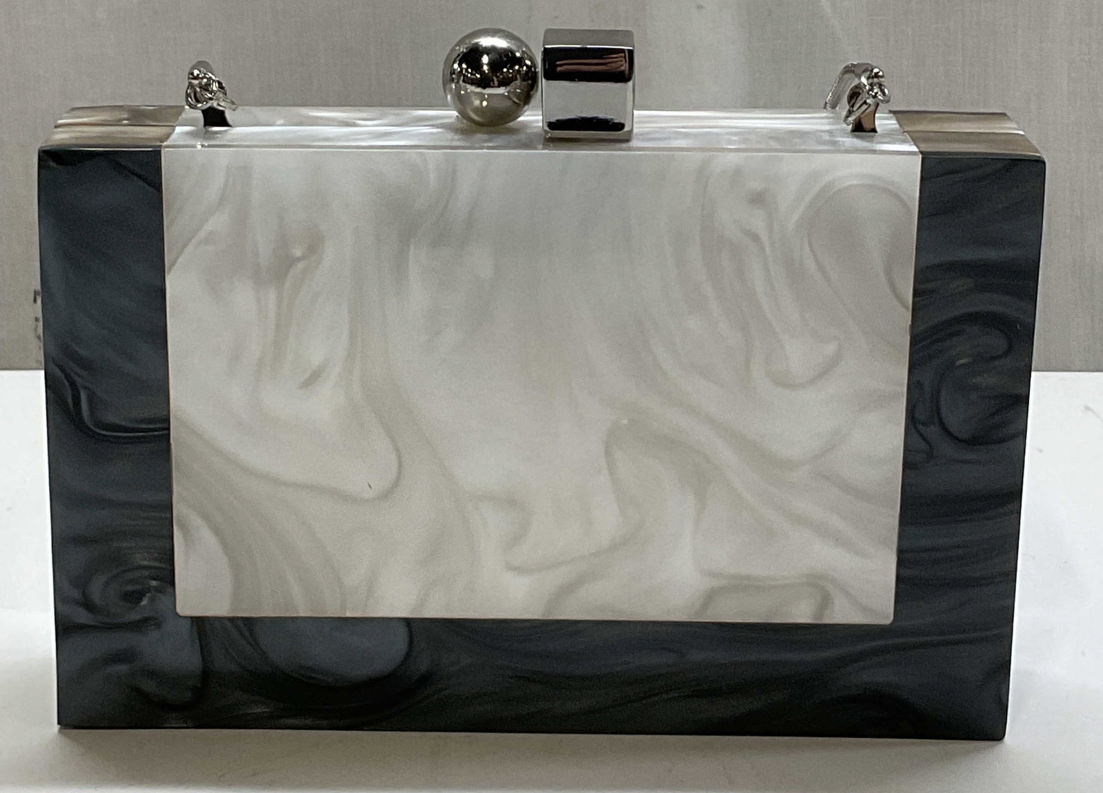 Zara Woman Marbled Acrylic Box Clutch: Zara Woman marbled acrylic box clutch. Rectangular shape. Black and white marble design. Decorative closure. Attached strap. Interior compartments. Measures approx 2 x 8 x 6 inches. Surface wear consi