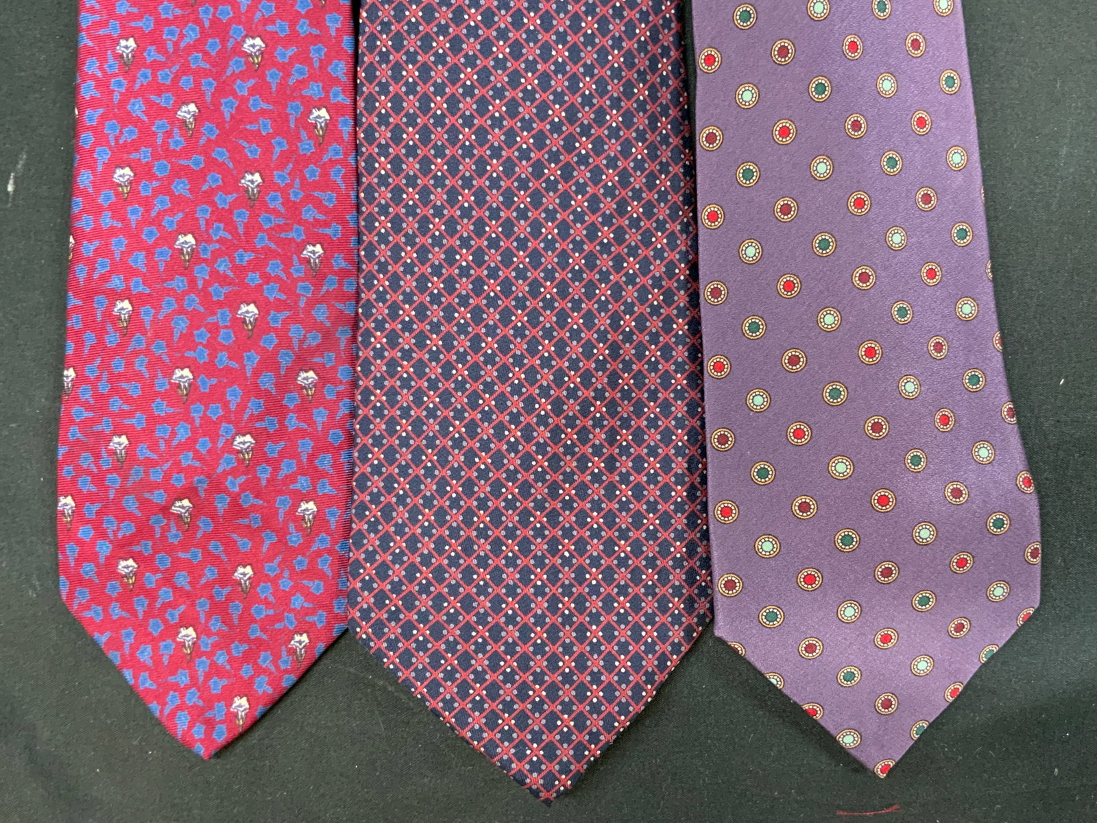 Vtg Lt3 Mens Silk Neckties: Vintage lot of 3 mens silk neckties. Includes 1x Ted Lapidus Paris red tie with solid blue floral pattern and white floral accents. 1x Cerruti CXII navy blue base woven with red diamond lattice and wh