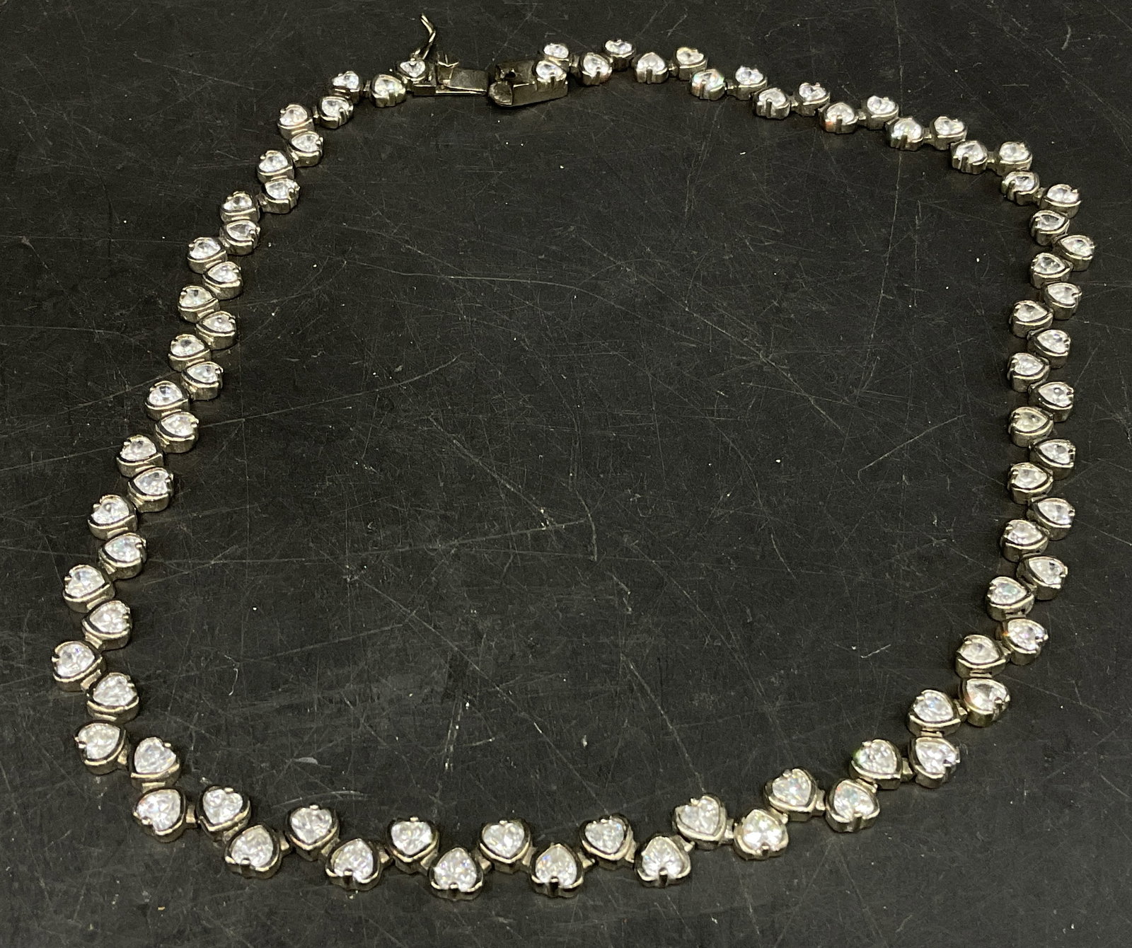 Silver-Toned Heart Tennis Necklace: Silver-Toned Heart Necklace. White heart-shaped rhinestones. Condition consistent with age and exposure. Measures approx 17in L. necklaces, rhinestones, hearts, costume jewelry, fashion accessories 8 