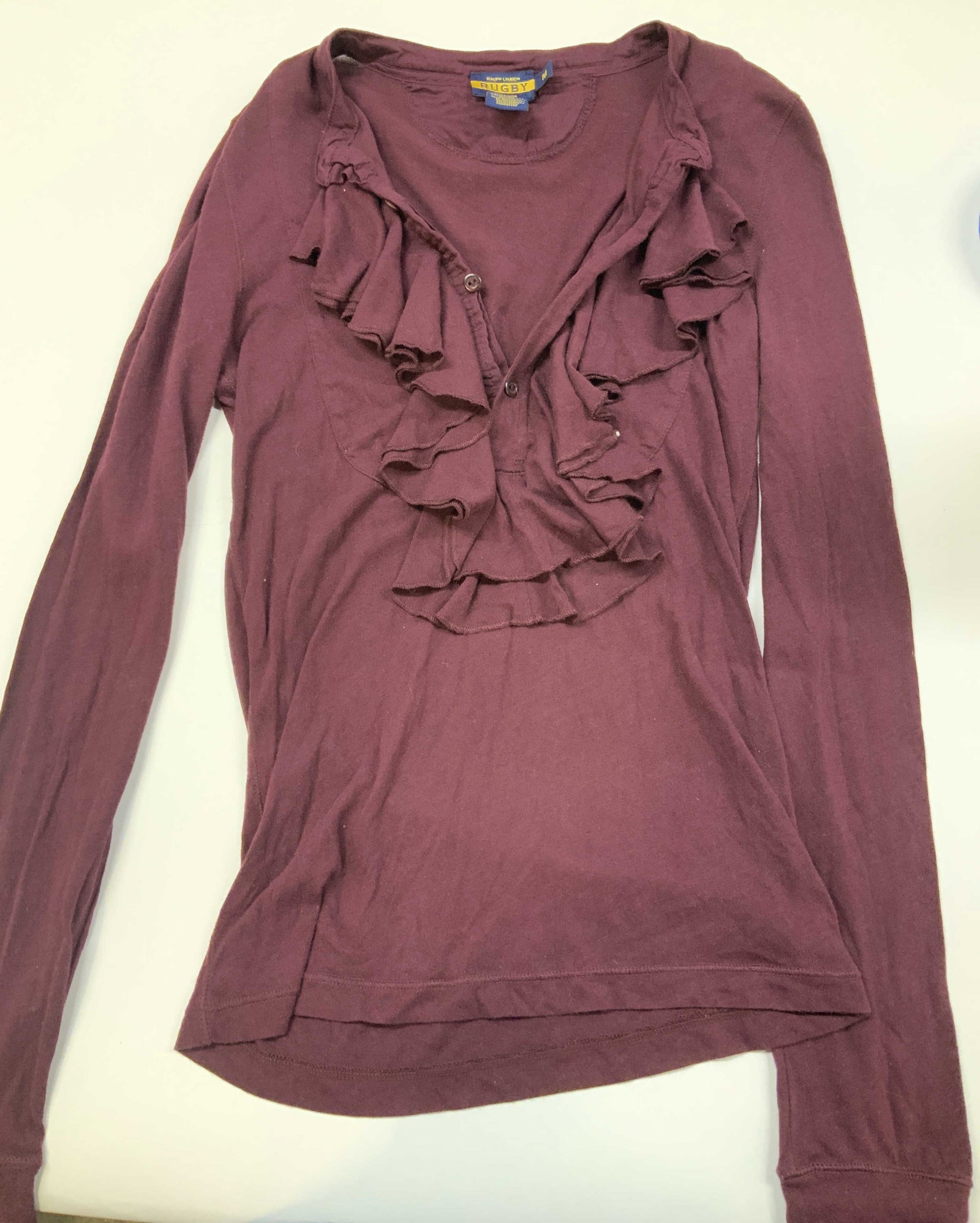 Vntg RUGBY by Ralph Lauren ruffle shirt ,2000s: Vintage RUGBY by Ralph Lauren ruffle shirt. Made in the 2000s in size medium. The standout feature is the multi layered cascade ruffle framing the neckline. It utilizes a partial button closure nestle
