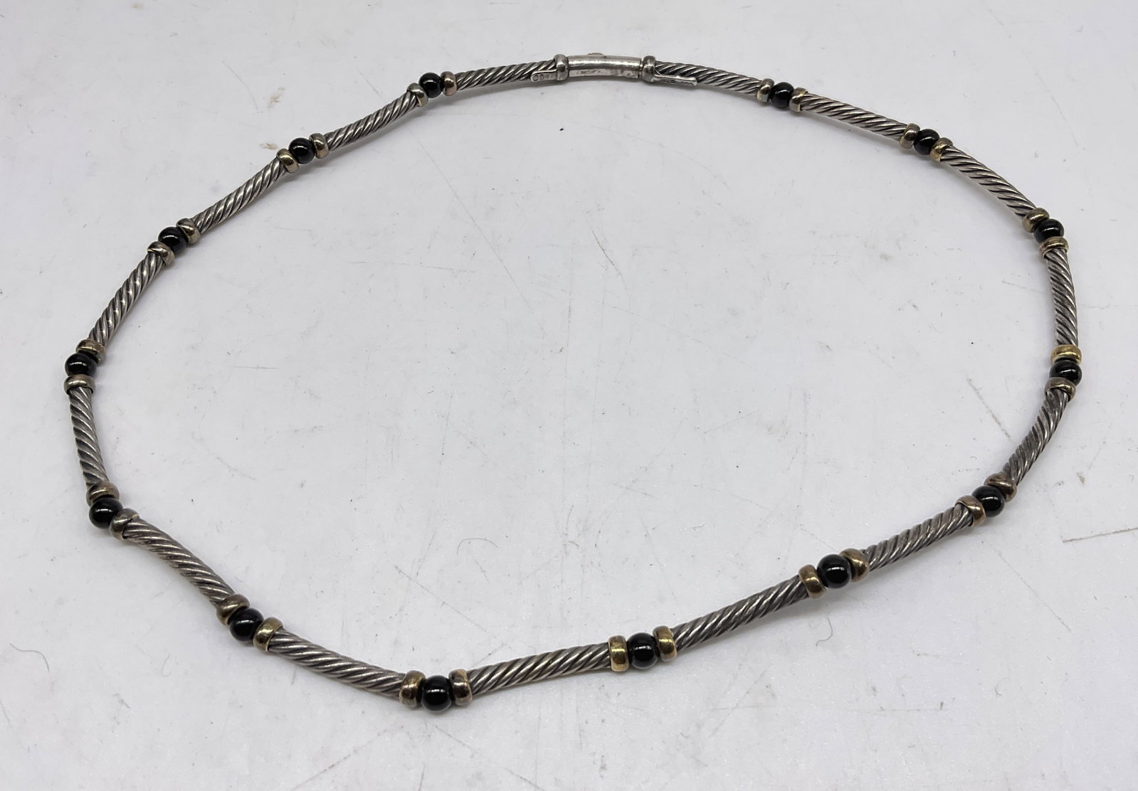 VTG David Yurman 14KGOLD&STER Choker Necklace: Vintage David Yurman 14K Gold and Sterling Silver Choker Necklace. Black stones, appears to be onyx. Marked 585 and 925. Tarnishing present. Measures approx 14.5in L. Total weight 20g. vintage
