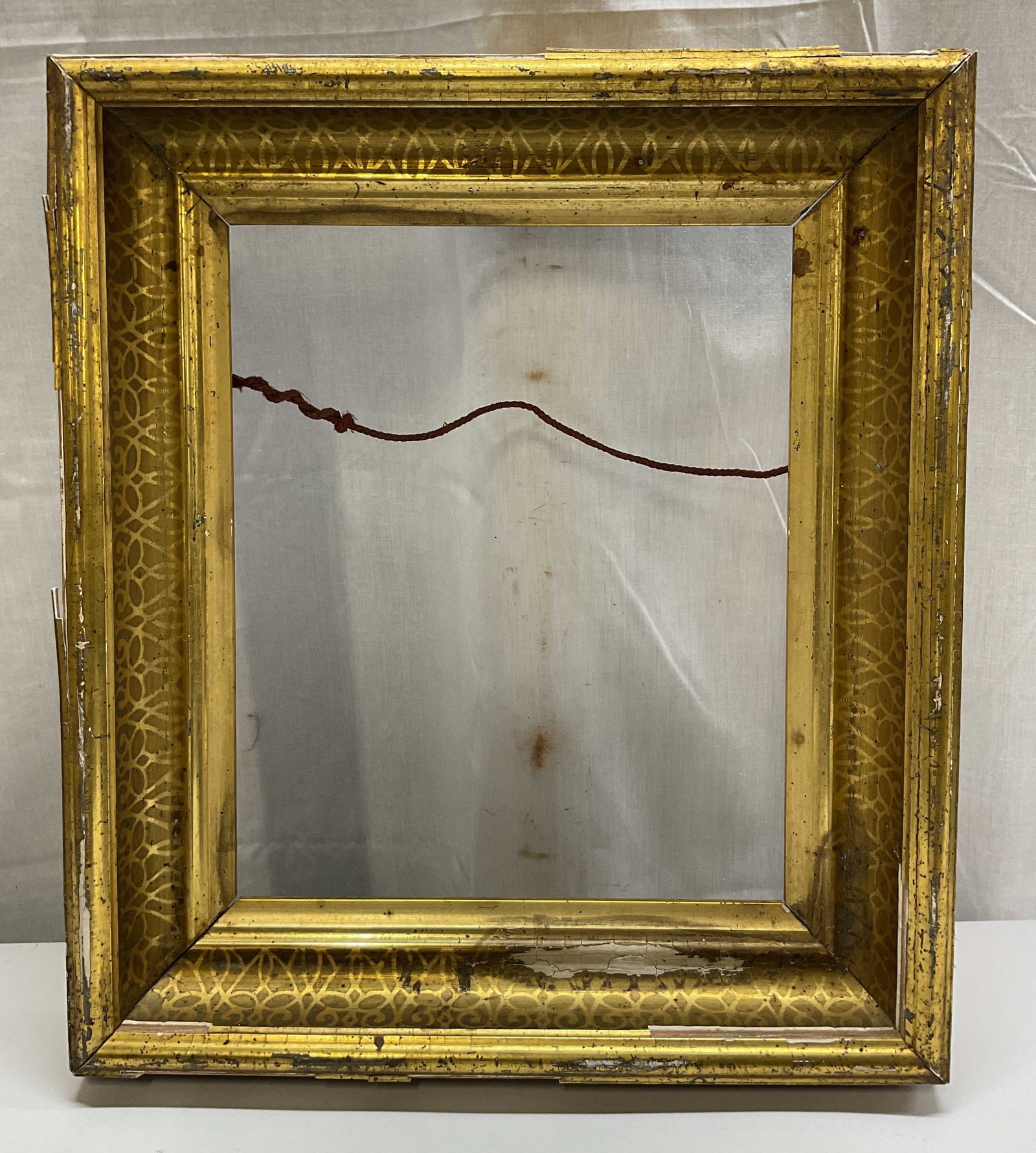 Antique Gilded Wood Frame: Antique gilded wood frame. Rectangular shape. Gilt design with ornate scroll motifs. Measures approx 14 x 16 inches. Scratching and chipping. Frame, picture frame, gilded frame, decor, home decor,