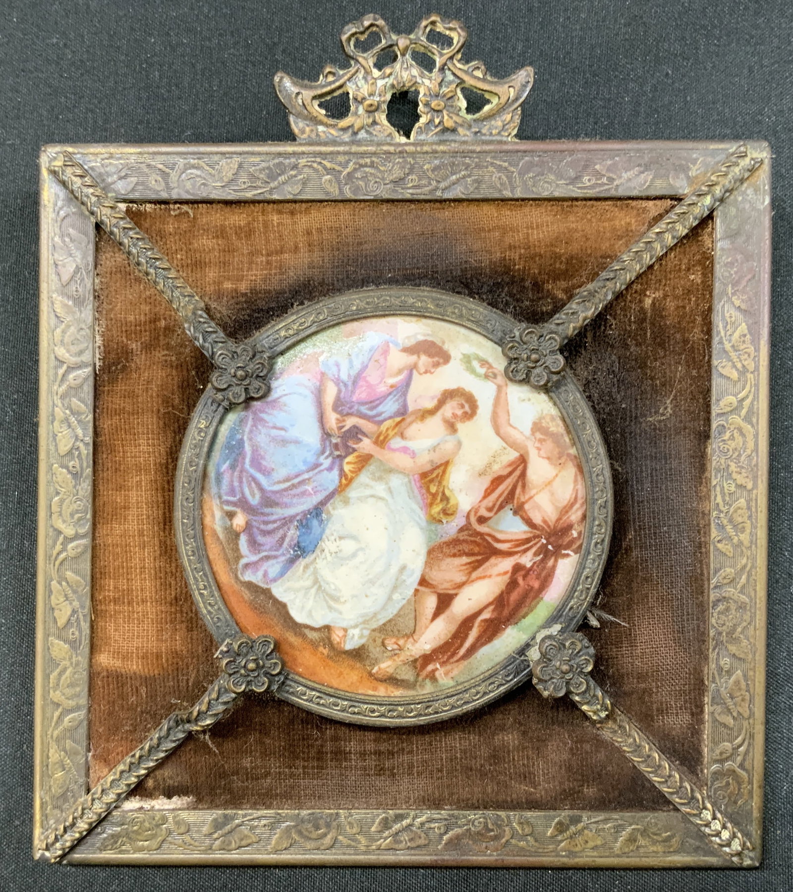Antique Ormolu Velvet Miniature Frame, France: Antique square portrait plaque features central circular porcelain disc with three allegorical female muses dressed in classical robes scene. Secured in decorative metal border ring with side floral r