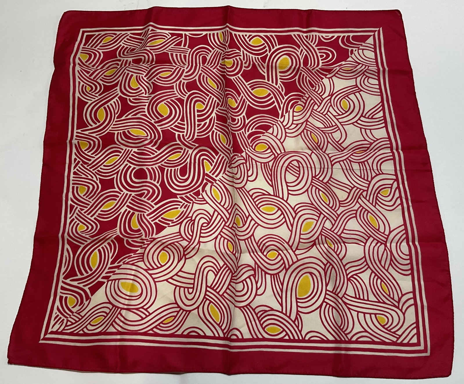 Vintage Pink Geometric Silk Scarf: Vintage pink geometric silk scarf. Pink border. White and yellow abstract geometric pattern. Split design. Measures approx 22 x 22.5 inches. Blemishes and light wear. Property of Upper East Side