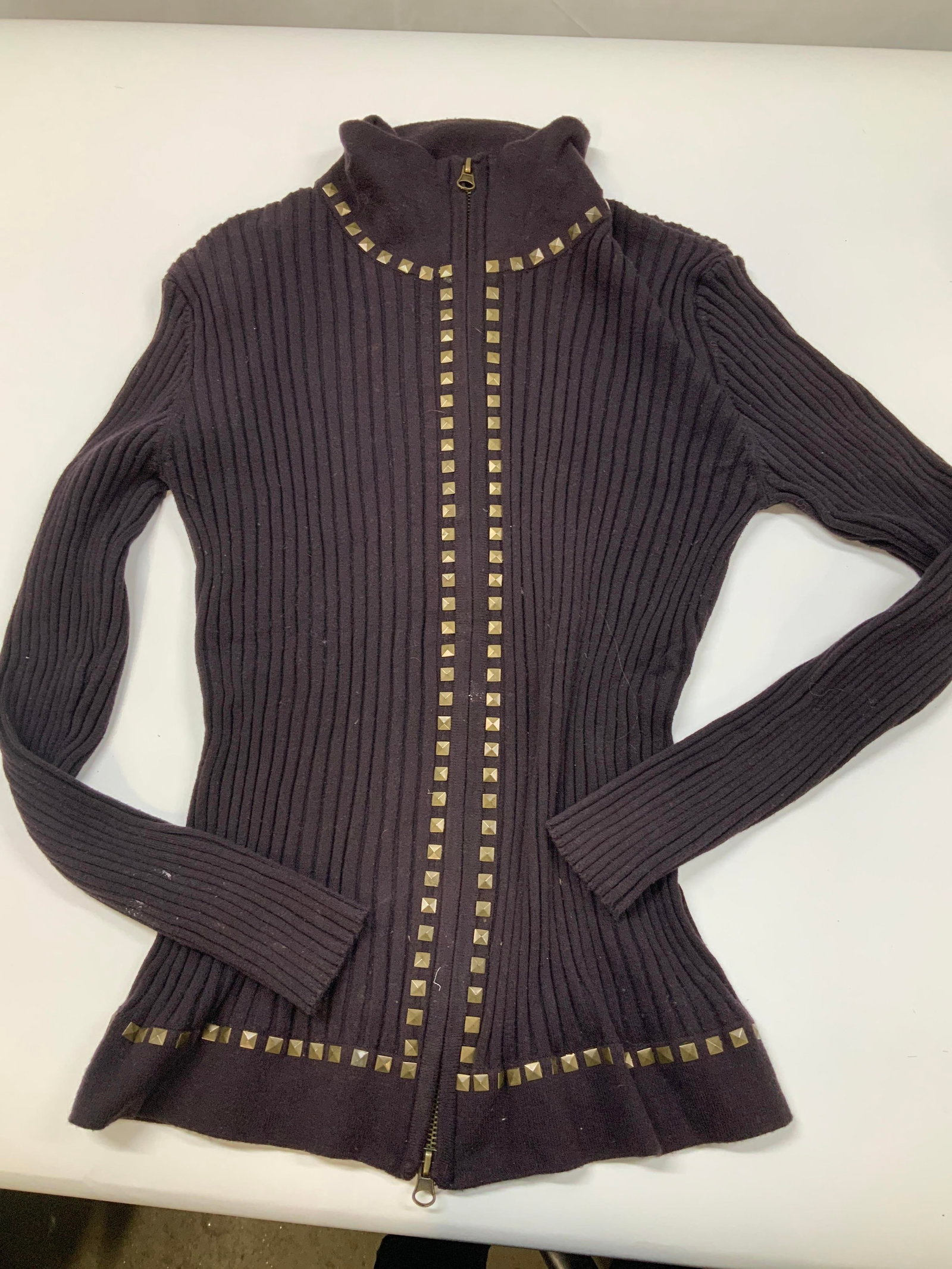 Vntg brown ribbed zip up jacket with studs: Vintage brown ribbed zip up jacket with studs. It features a thick vertical, wide ribbed knit pattern. Outlined with two parallel tracks of square dull gold toned pyramid studs running along the from
